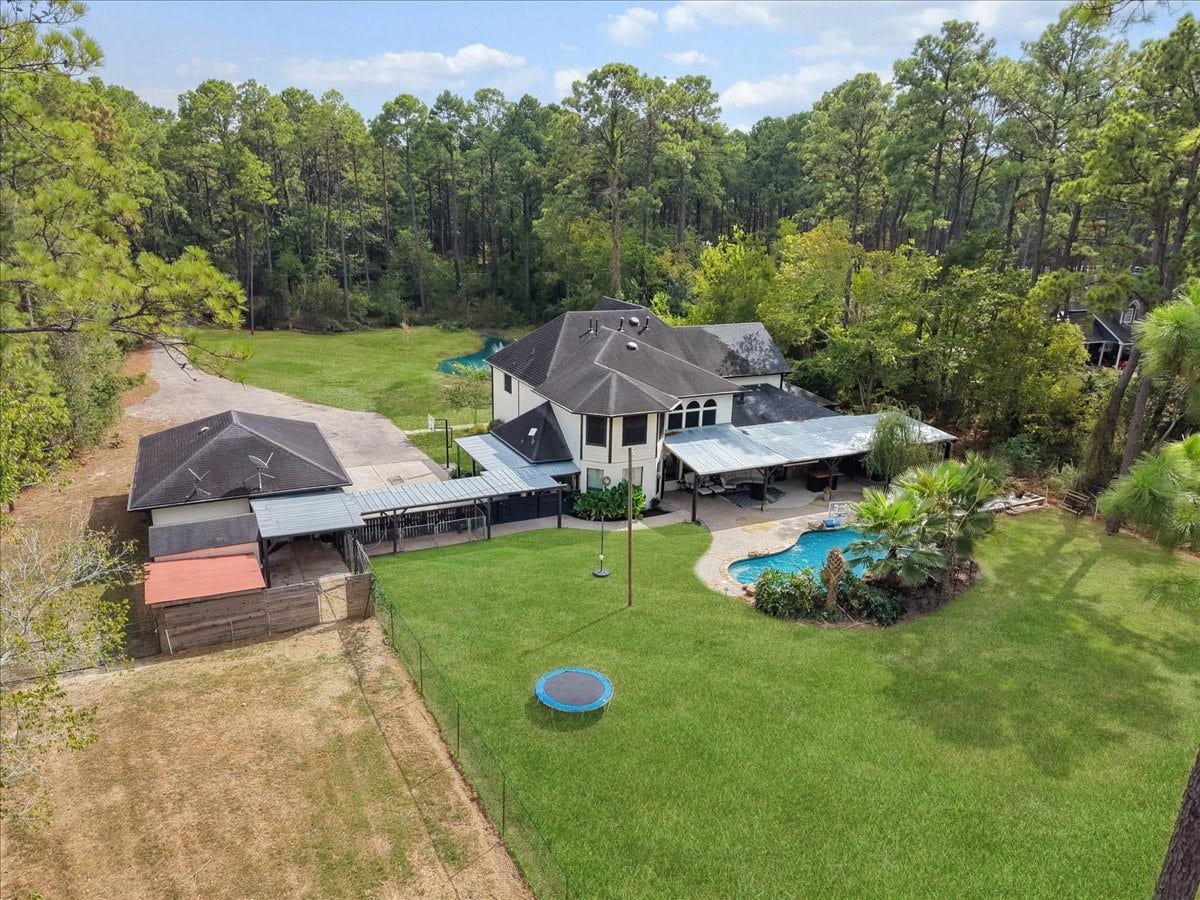 7202 Pine Drive W, Alvin, TX 77511 Discover a spacious home nestled in a lush, wooded setting, featuring a large backyard with a sparkling pool and ample patio space, perfect for outdoor entertaining and relaxation. Also, a private airconditioned doghouse with running water.