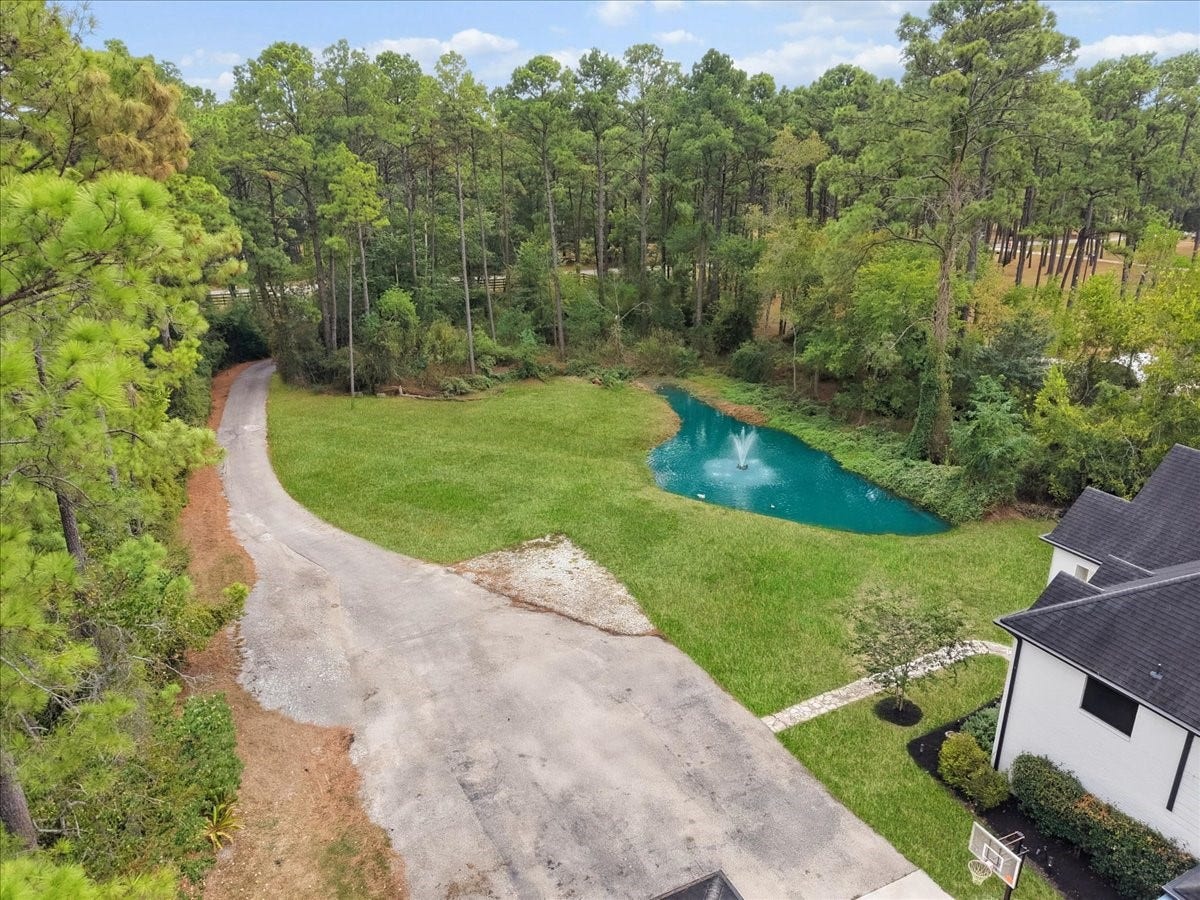 7202 Pine Drive W, Alvin, TX 77511 Enjoy your private gated entrance to this wooded 5 acres, and private stocked pond.