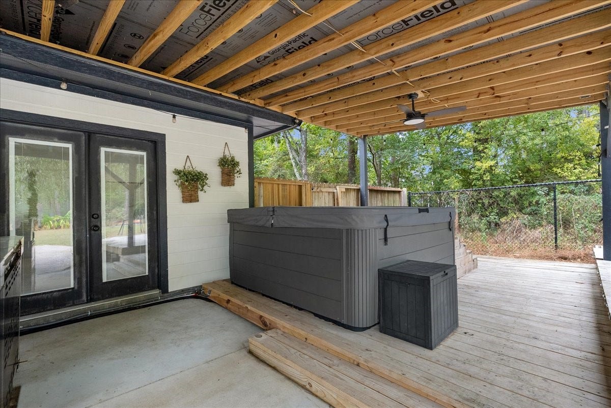 7202 Pine Drive W, Alvin, TX 77511 Enjoy a covered outdoor retreat featuring a spacious hot tub, perfect for relaxation and entertainment, with easy access through elegant French doors.