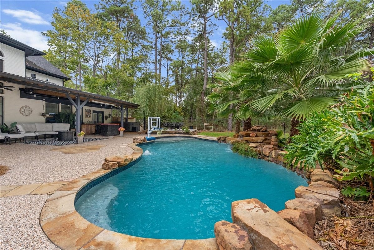 7202 Pine Drive W, Alvin, TX 77511 A recently replastered pool and new coping, surrounded by tropical palms and lush landscaping, accentuates paradise.