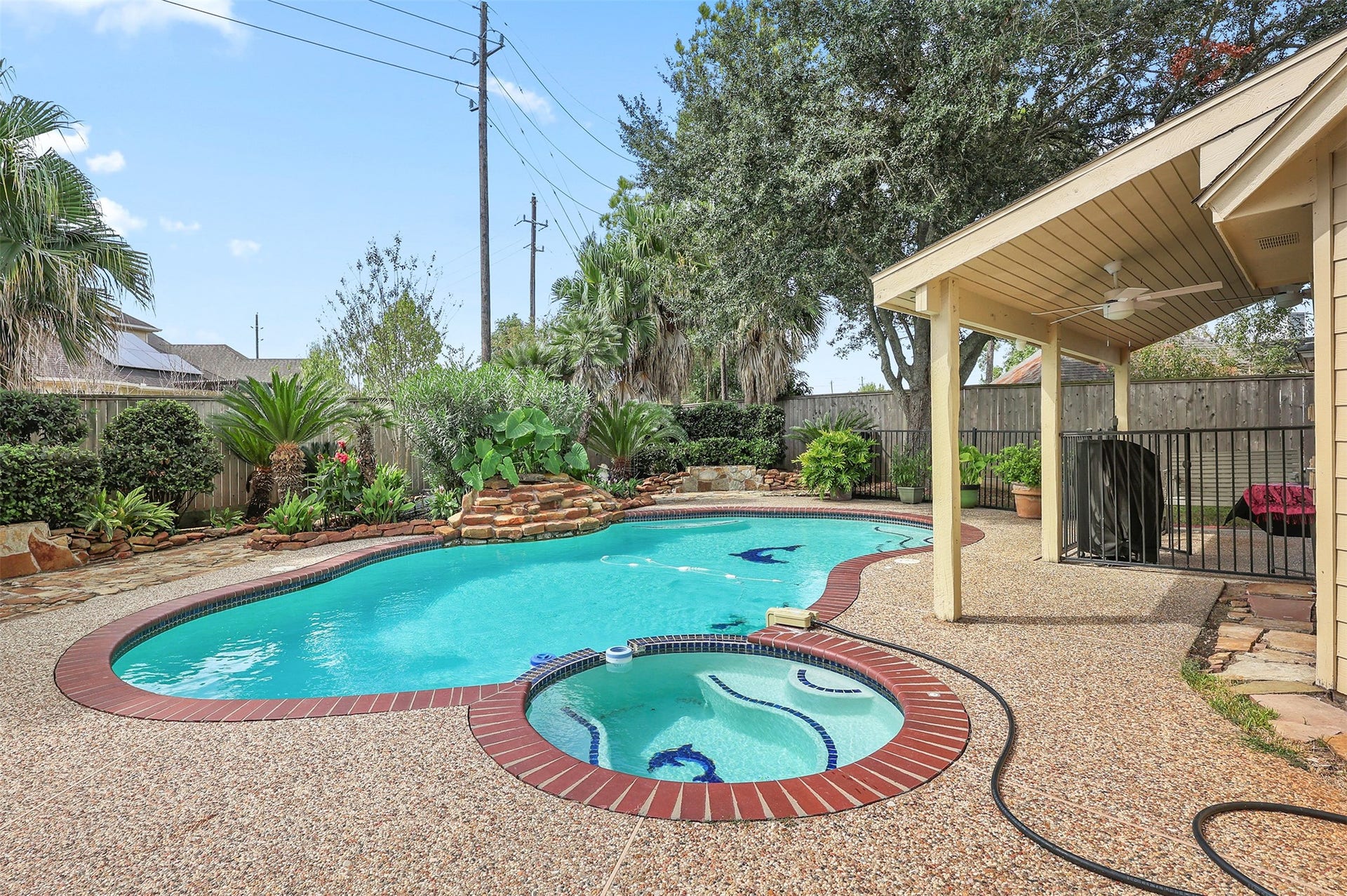 3424 Glastonbury Drive, Pearland, TX 77581 Relax in your sparkling pool with waterfall, surrounded by lush landscaping and a cozy covered patio perfect for entertaining.