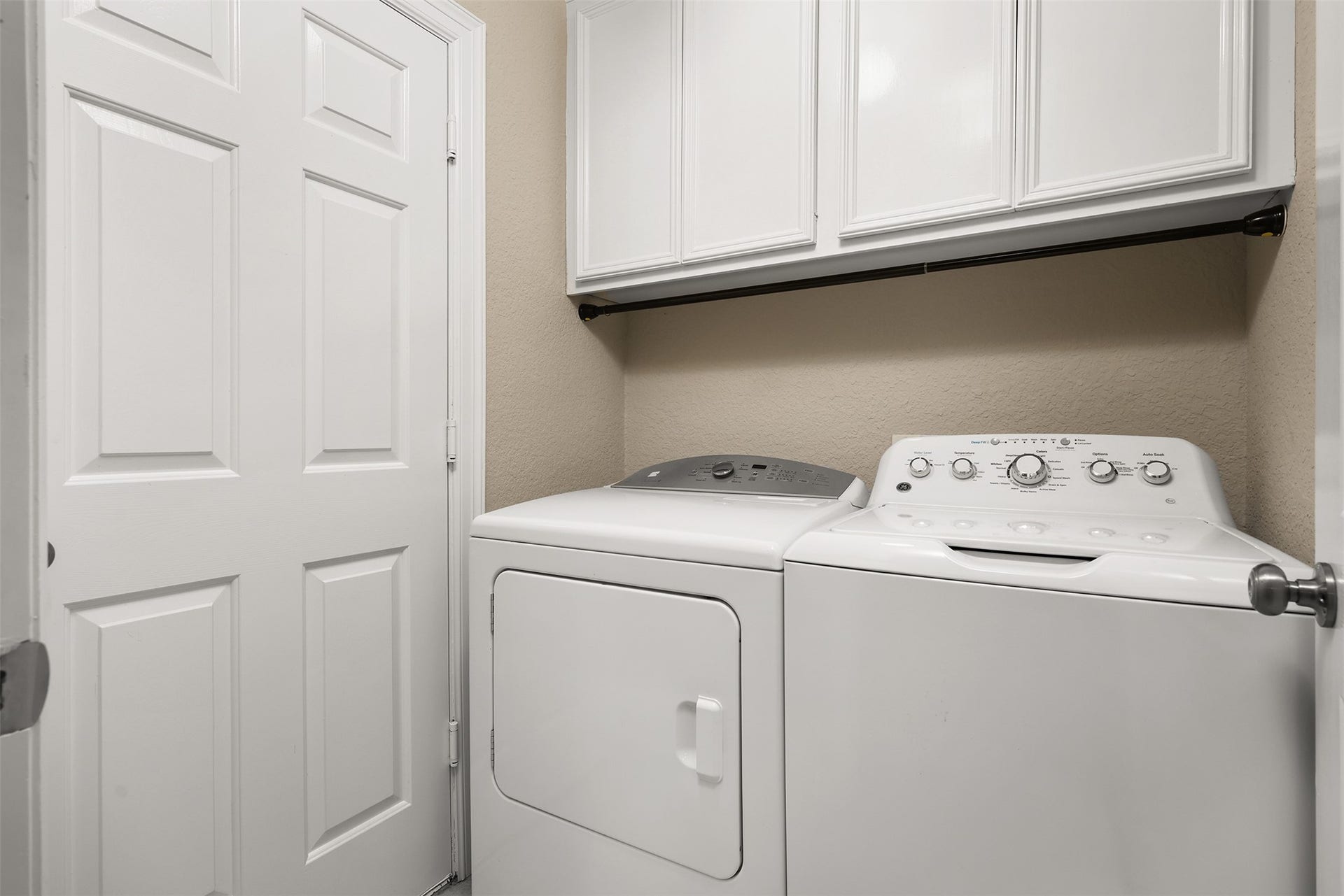3424 Glastonbury Drive, Pearland, TX 77581 Efficient laundry room featuring ample cabinet storage, and a convenient layout with access to the two car garage.