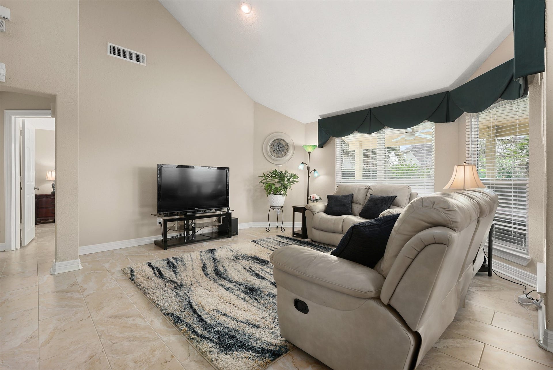 3424 Glastonbury Drive, Pearland, TX 77581 Spacious living room with high ceilings, natural light from large windows and ceramic tile flooring.