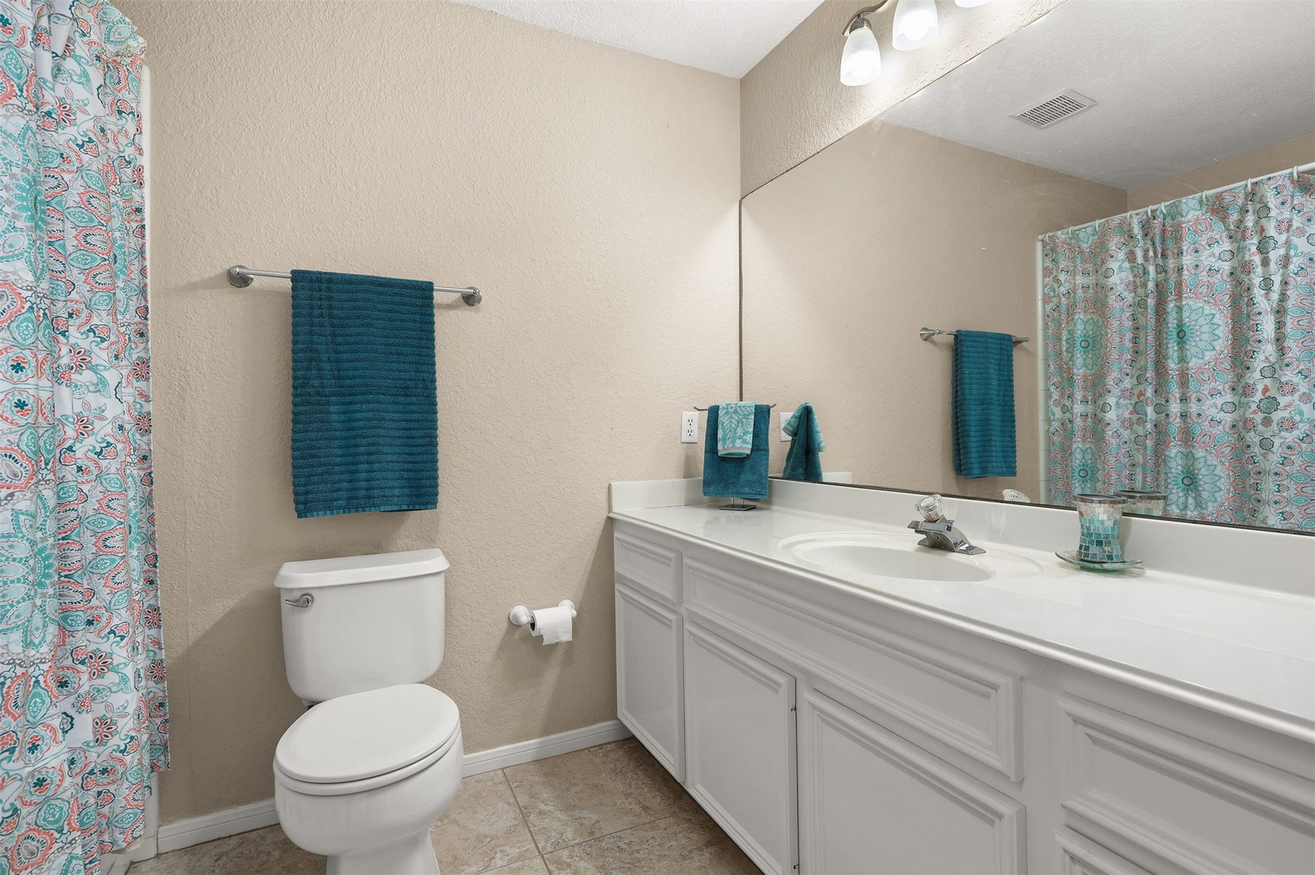 3424 Glastonbury Drive, Pearland, TX 77581 Bright bathroom with a large mirror, elegant white vanity, and ample storage.