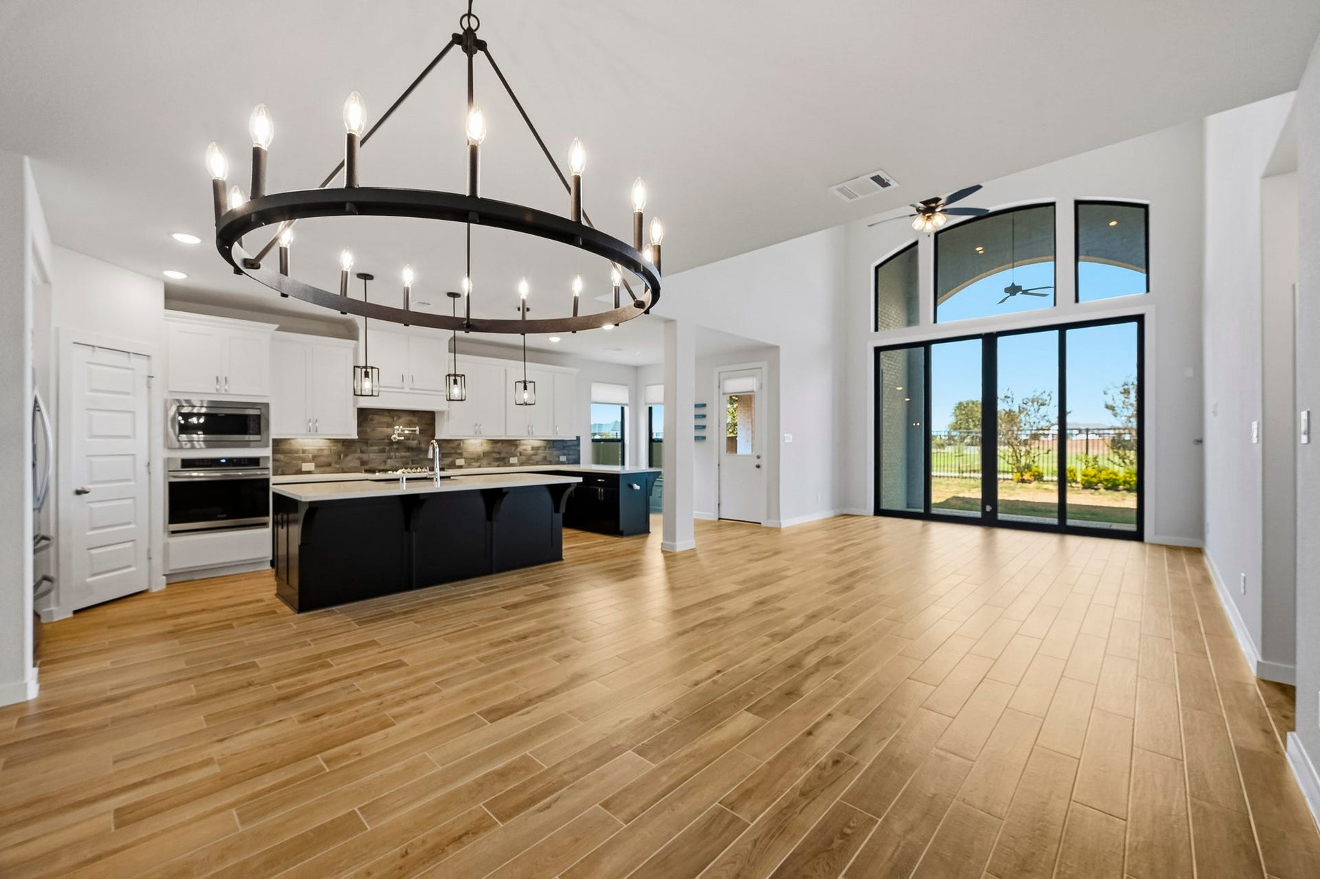 Walking in, you are greeted by a light and open space! This huge open layout will not disappoint and offers high ceilings, recessed lighting, a beautiful chandelier, and large windows and sliding glass doors letting in tons of natural light.