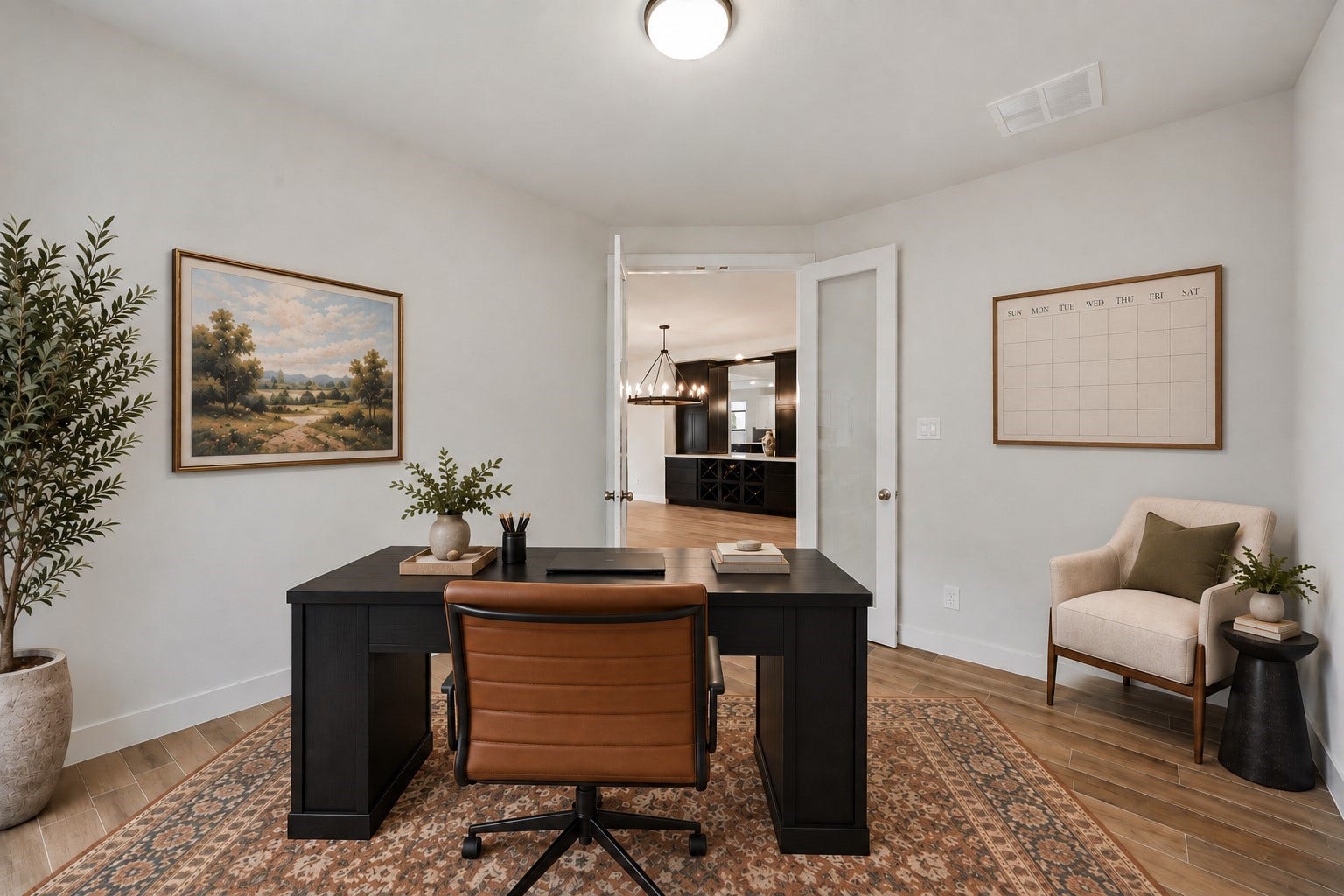 Tucked off the main living areas is the home office! Featuring wood-tile flooring, neutral paint, bright natural light, and timeless glass French doors.   *This room has been virtually staged