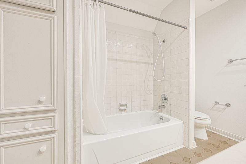 9907 Sagegreen Drive, Houston, TX 77089 Bright and inviting bathroom featuring a classic tile shower-tub combo, ample storage with cabinetry, and a neutral palette for a serene atmosphere.