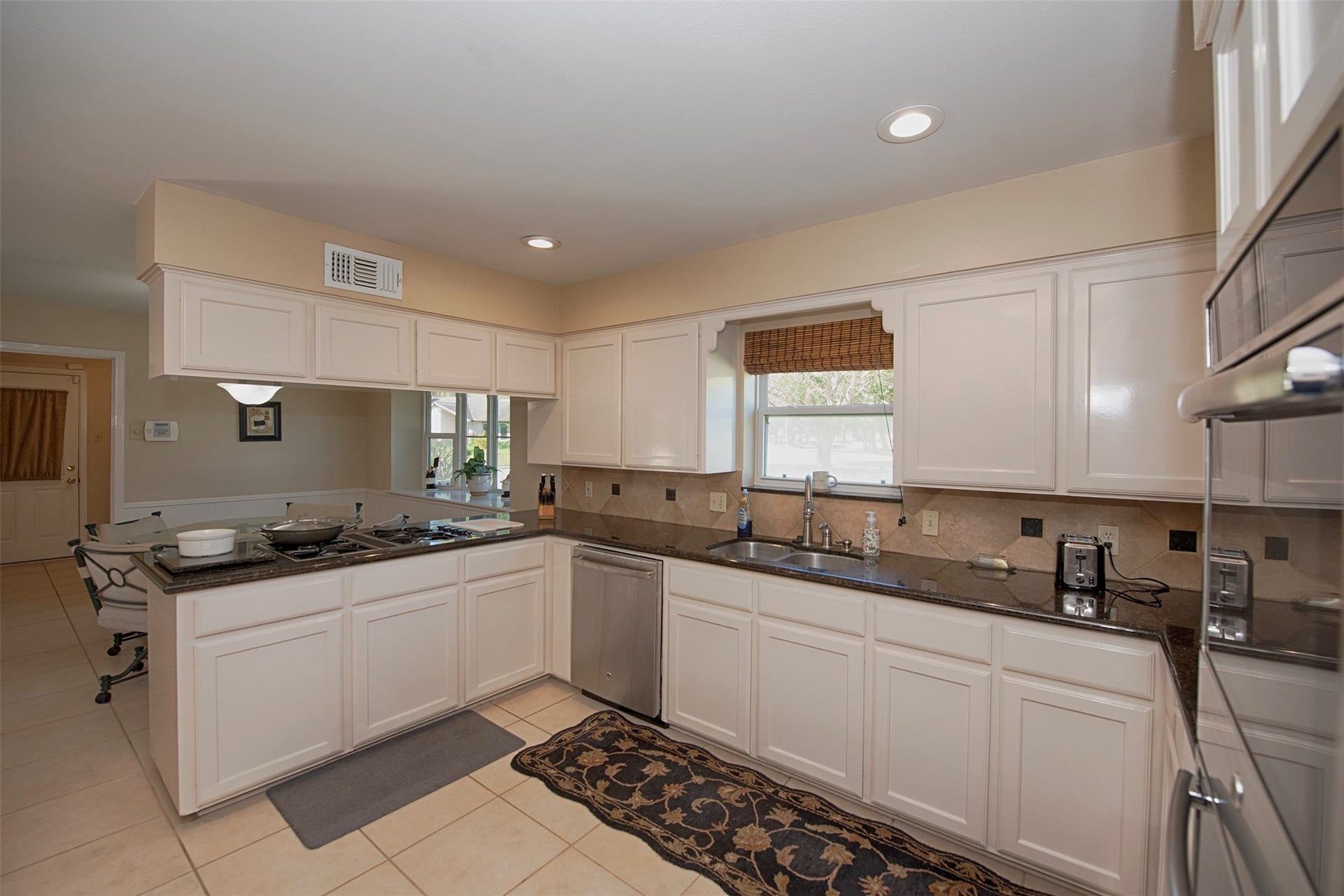18502 Vinland Drive, Nassau Bay, TX 77058 Entry to the updated kitchen with updated granite counters and fabulous storage.