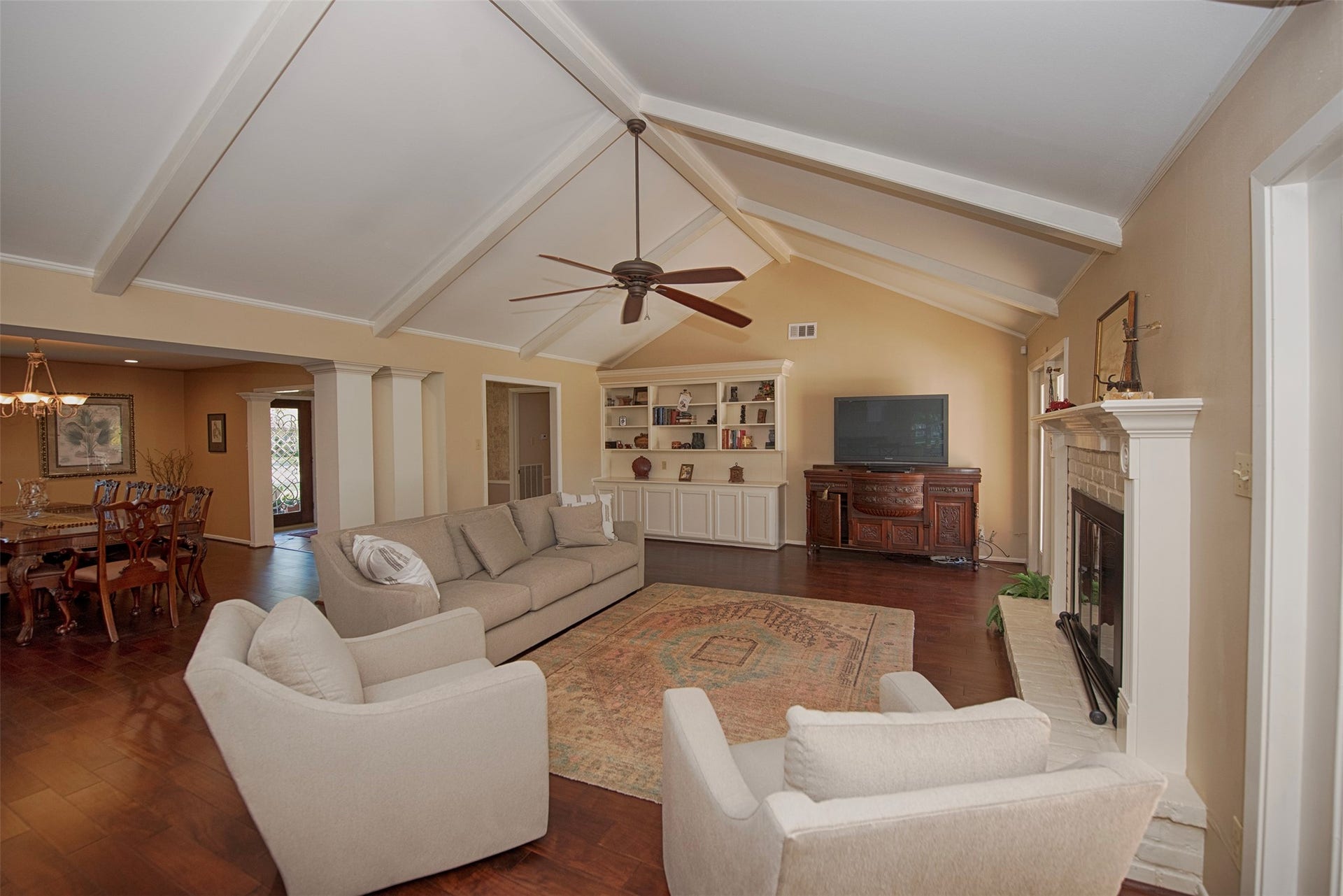 18502 Vinland Drive, Nassau Bay, TX 77058 A view of the family room with high ceilings and gorgeous wood beams that has easy access to the formal dining room.