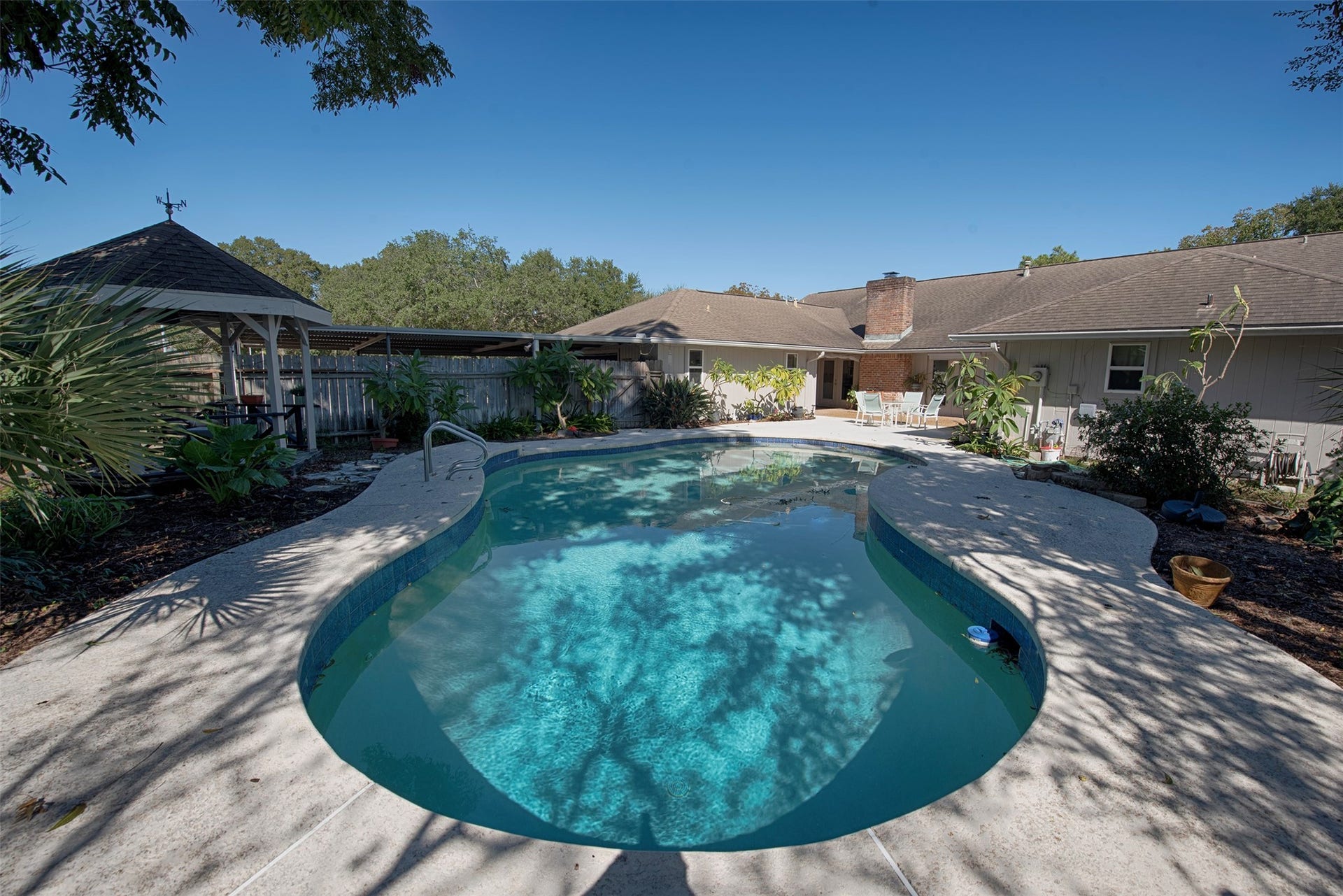18502 Vinland Drive, Nassau Bay, TX 77058 A view of the pool to the house and patio. There is even a Gazebo for those sensitive to the sun.