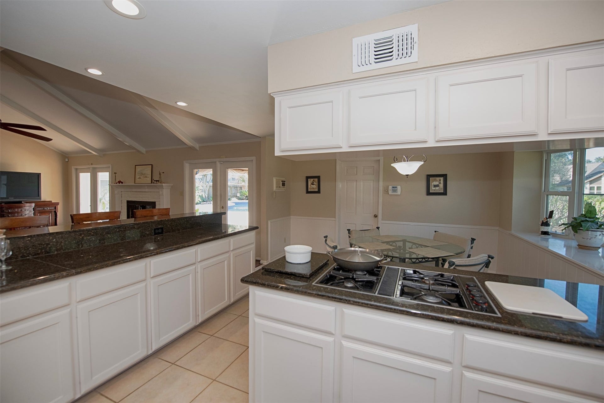 18502 Vinland Drive, Nassau Bay, TX 77058 A view of the kitchen showing the counter range top open to the casual dining area and open to the family room.