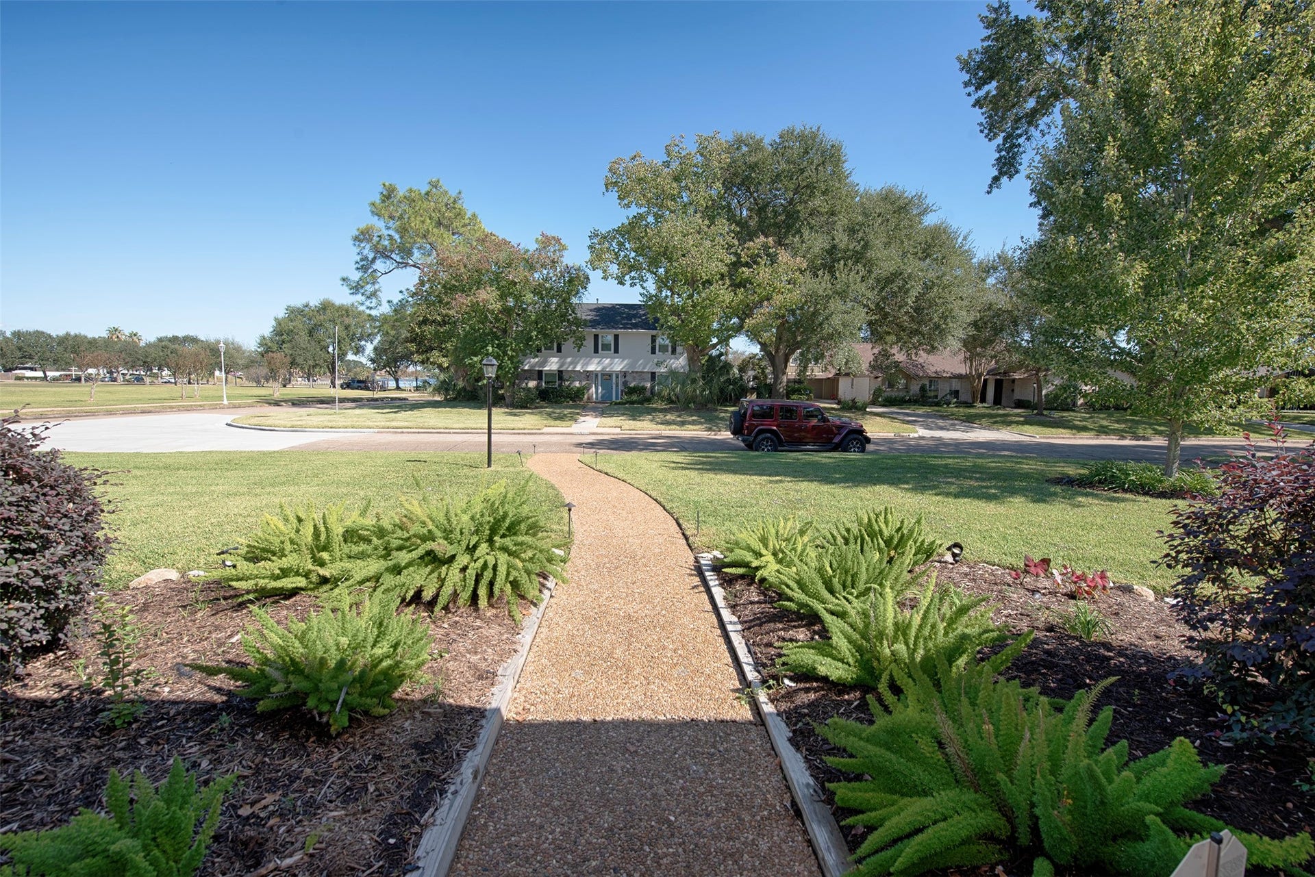 18502 Vinland Drive, Nassau Bay, TX 77058 From the front porch a view of the stunning landscaping and quiet neighborhood.