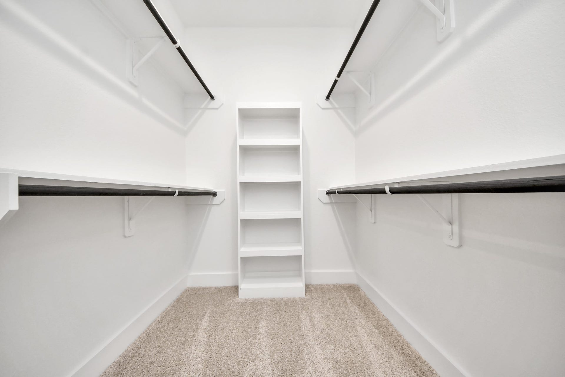 2056 Thimbleberry Lane, Magnolia, TX 77355 Walk-in closet that epitomizes luxury and practicality. This generously sized space features built-in shelving, offering abundant room for impeccable organization. High ceilings and recessed lighting create a bright and welcoming ambiance.