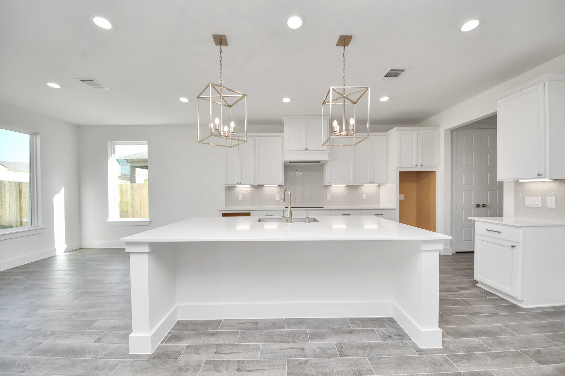 2056 Thimbleberry Lane, Magnolia, TX 77355 This kitchen is by far any chefs dream! This spacious kitchen features high ceilings, stained wood cabinets, granite countertop, SS appliances, modern tile backsplash, recessed lighting, extended counter space, granite kitchen island with double sink, and space for breakfast bar, and a walk-in pantry all overlooking your huge family room.