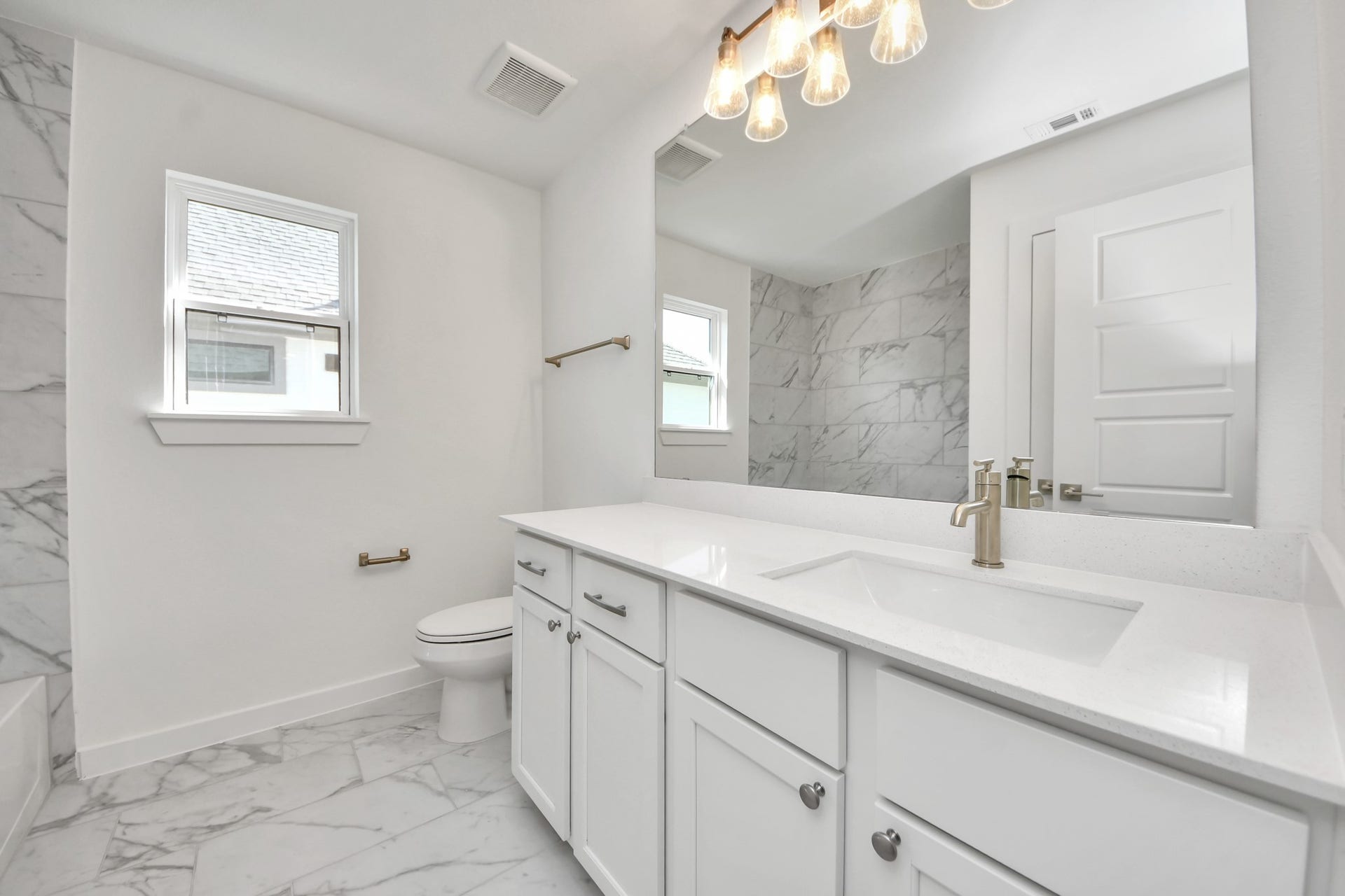2056 Thimbleberry Lane, Magnolia, TX 77355 Secondary bath features tile flooring, bath/shower combo with tile surround, light stained wood cabinets, beautiful light countertop.