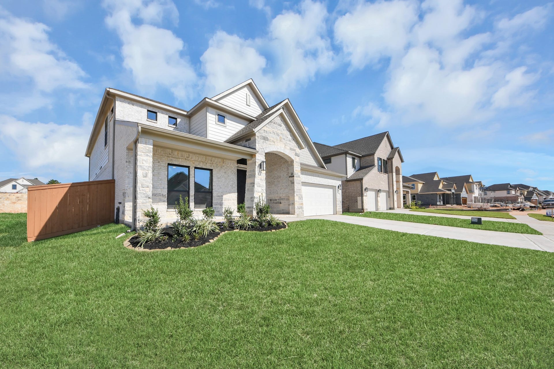 2056 Thimbleberry Lane, Magnolia, TX 77355 The residence features a practical 2-car garage complemented by a generous driveway, ensuring abundant space for parking needs.