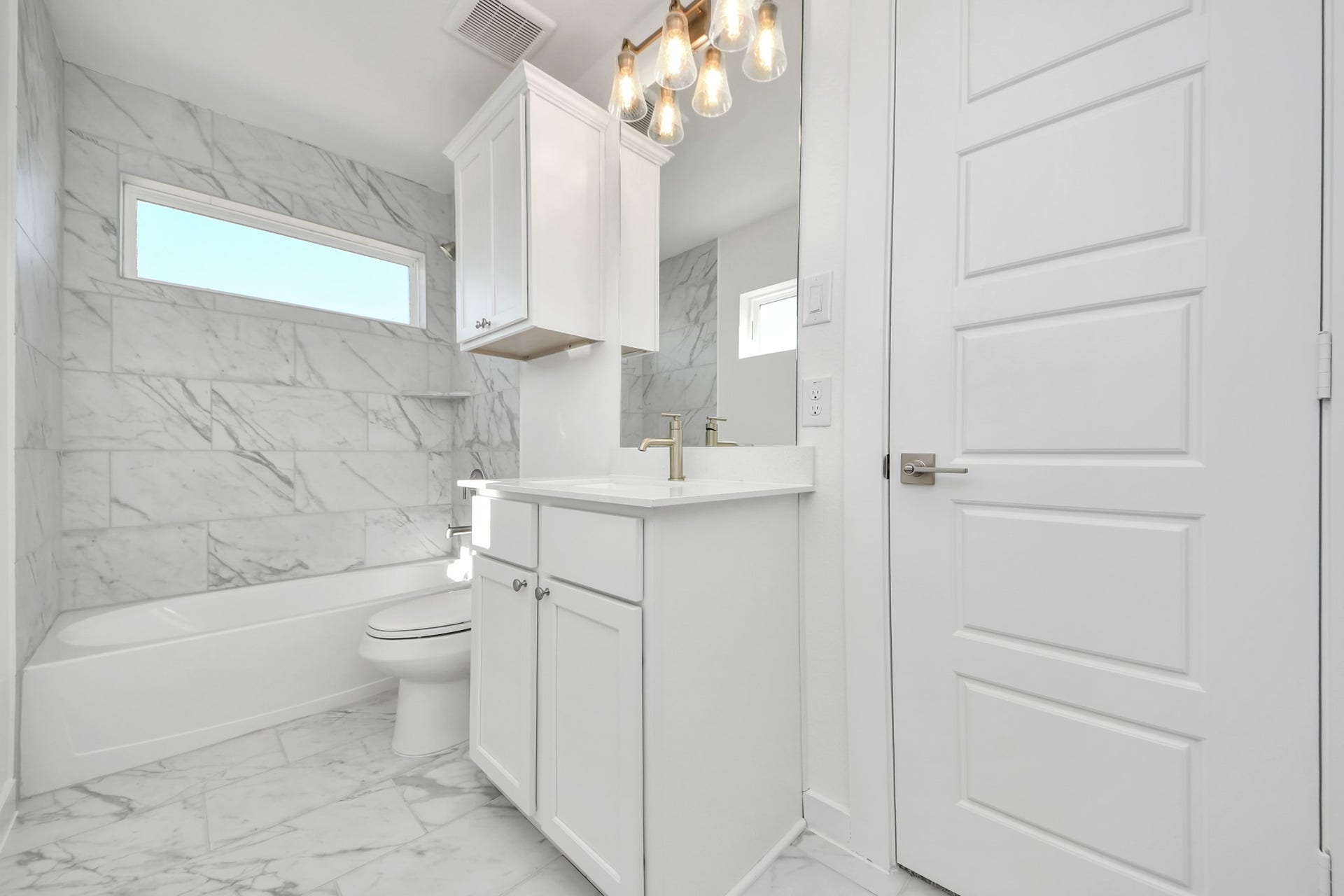 2056 Thimbleberry Lane, Magnolia, TX 77355 Secondary bath features tile flooring, bath/shower combo with tile surround, light stained wood cabinets, beautiful light countertop.