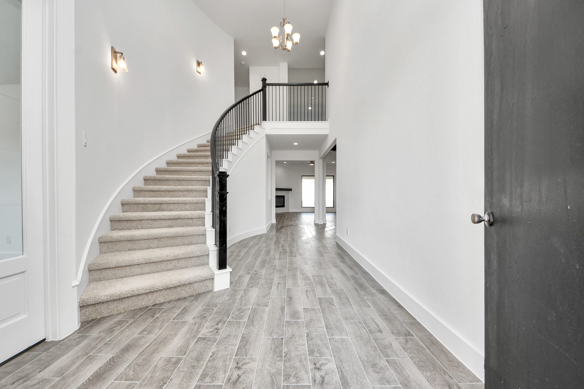 2056 Thimbleberry Lane, Magnolia, TX 77355 As you step into the threshold of this luxurious home, you'll soon be welcomed by an elegant glass door (to be installed). Inside, soaring ceilings amplify the spaciousness, while the refined wood-look tile flooring and oversized baseboards exude sophistication and charm.