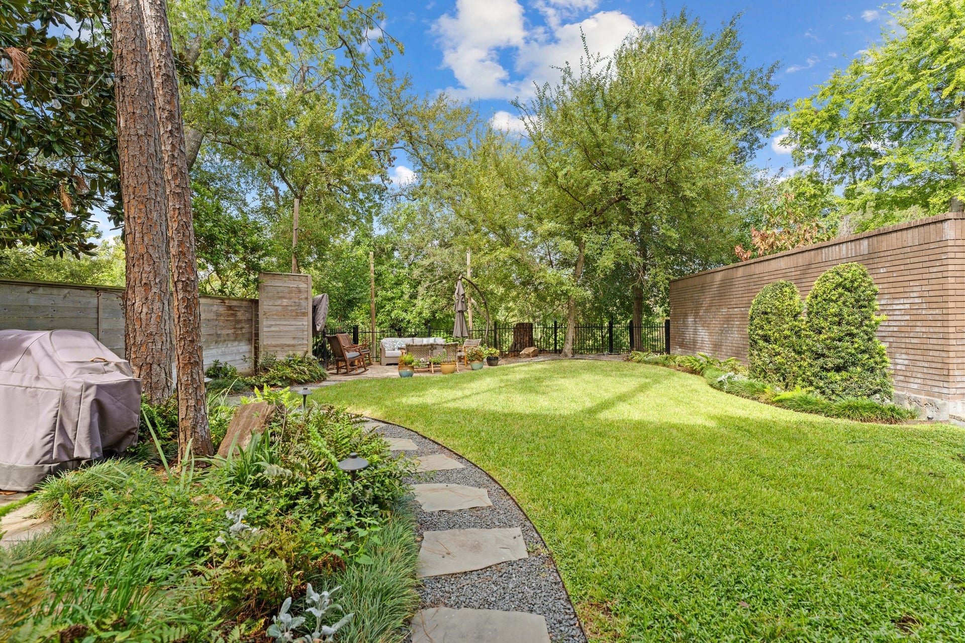 1918 Stoney Brook Drive, Houston, TX 77063 A curved stone path leads through landscaped beds to a garden patio. The fenced yard includes approximately 1,890 sq. ft. of adjoining Harris County-owned land that you get to use- but don't pay for!