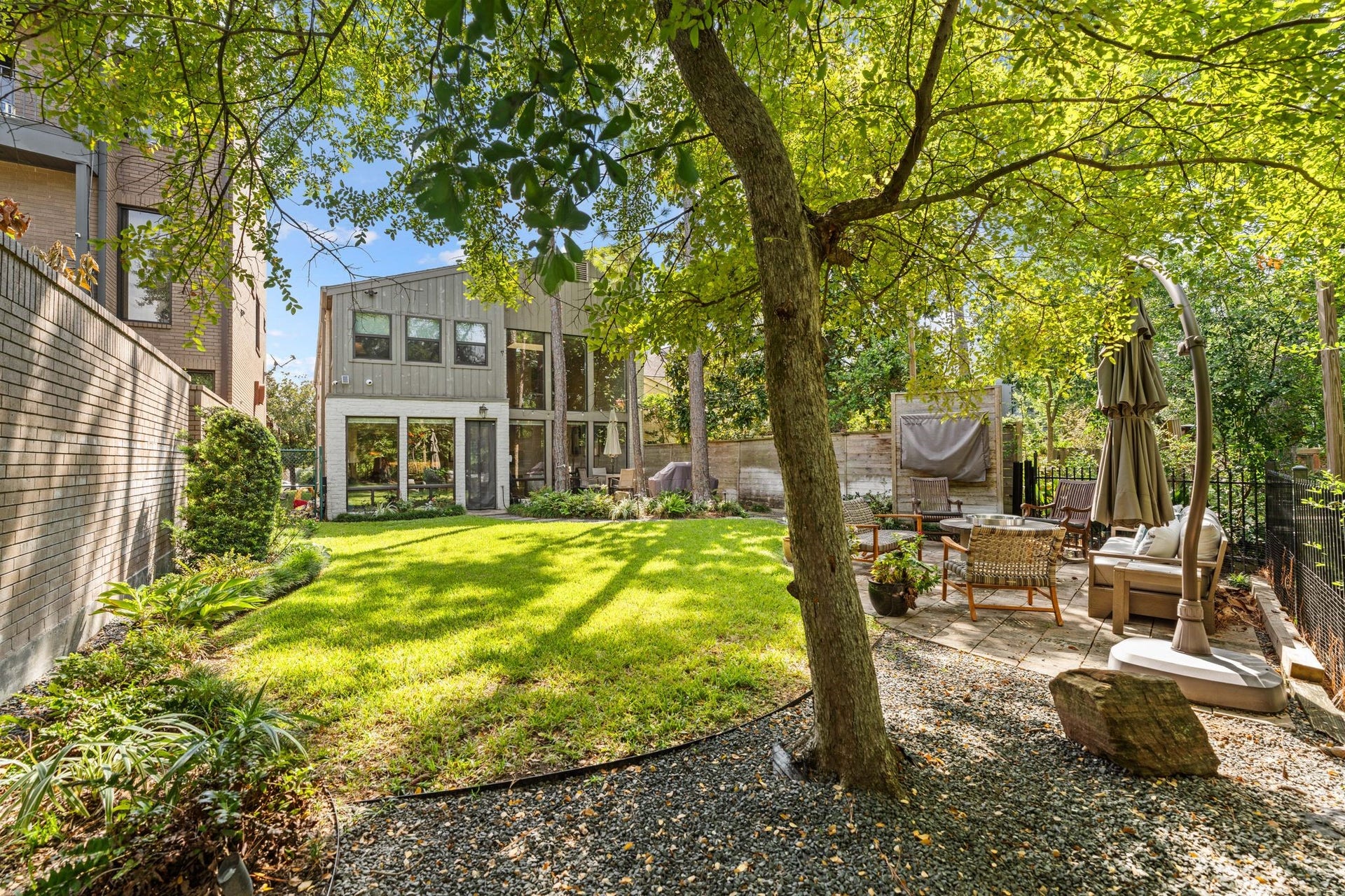 1918 Stoney Brook Drive, Houston, TX 77063 Shade trees, a lush lawn and a sitting patio create an inviting outdoor setting. The fenced yard includes approximately 1,890 sq. ft. of adjoining Harris County-owned land outside the deeded lot; buyer to verify continued use.