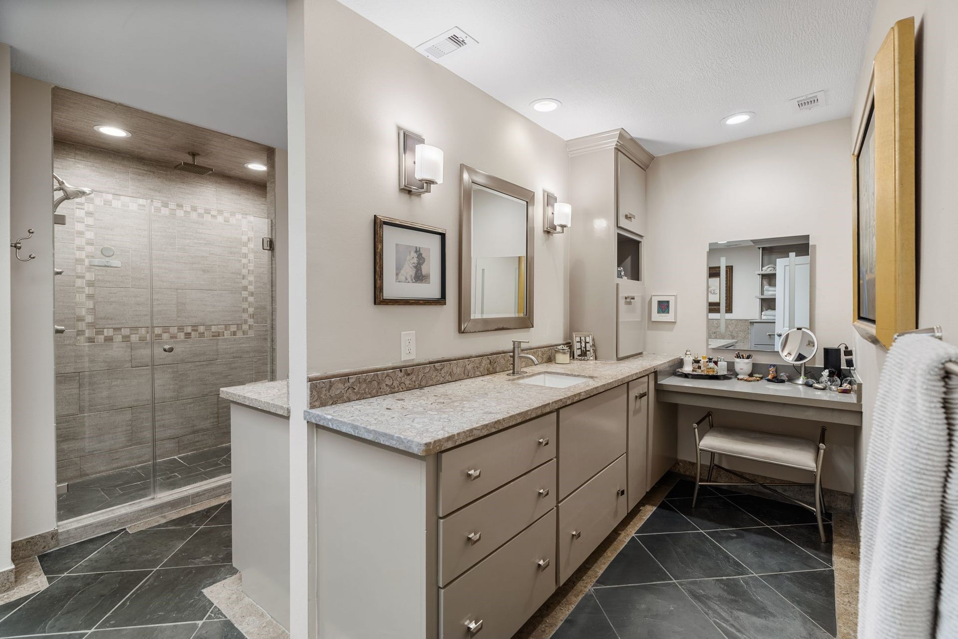 1918 Stoney Brook Drive, Houston, TX 77063 The back to back vanities create a separate space while still in the same area. The generous drawer storage and a dedicated makeup station bring everyday convenience to the primary bath.
