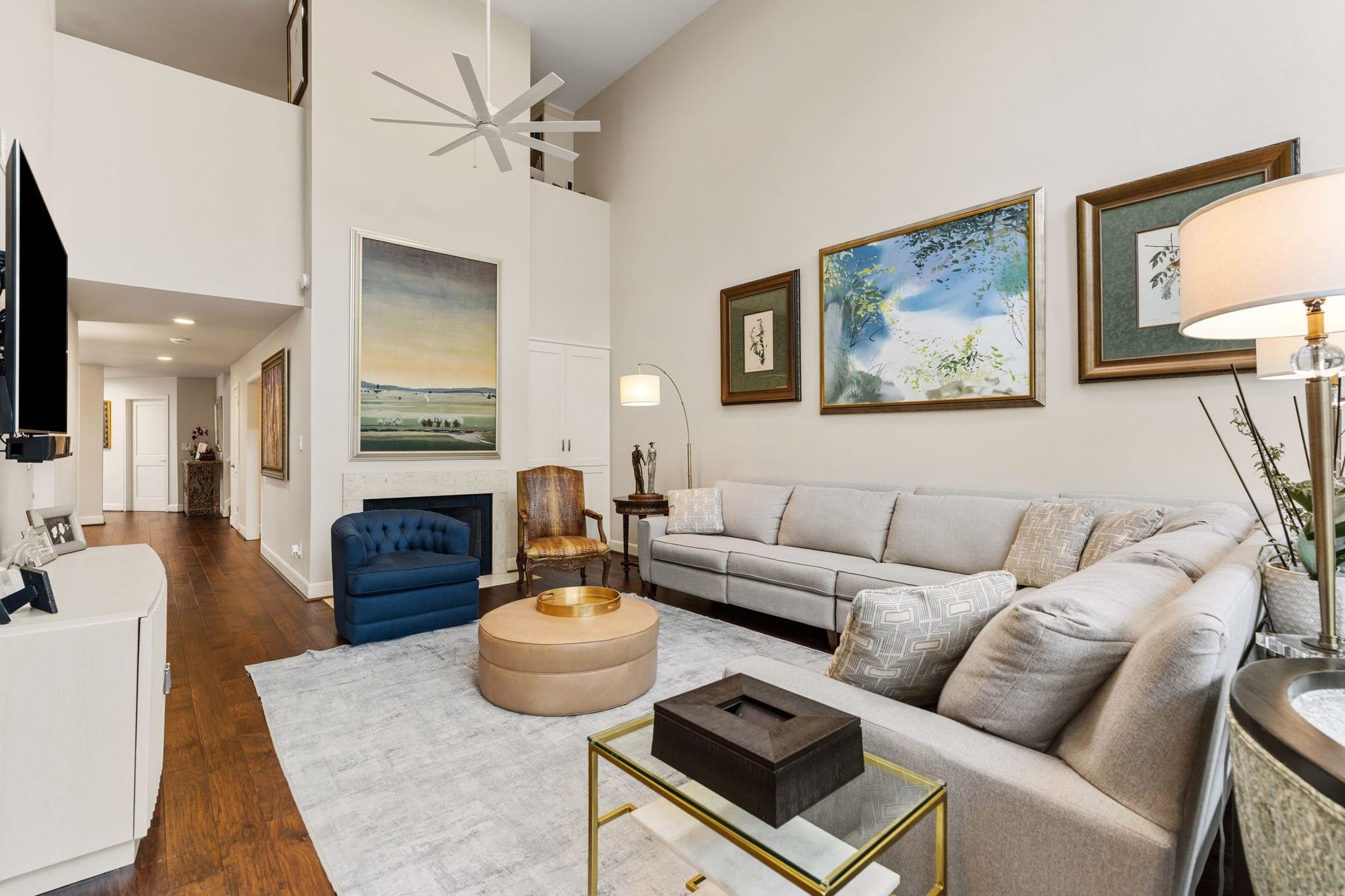 1918 Stoney Brook Drive, Houston, TX 77063 A fireplace and built-in cabinetry anchor the living room, while soaring walls provide generous space to display artwork.