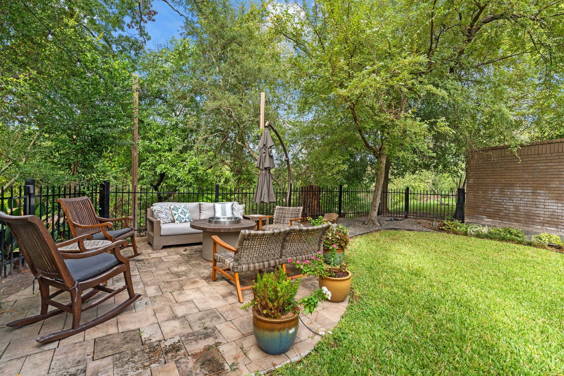 1918 Stoney Brook Drive, Houston, TX 77063 A garden sitting area surrounded by mature trees creates a peaceful spot for conversation and relaxation.