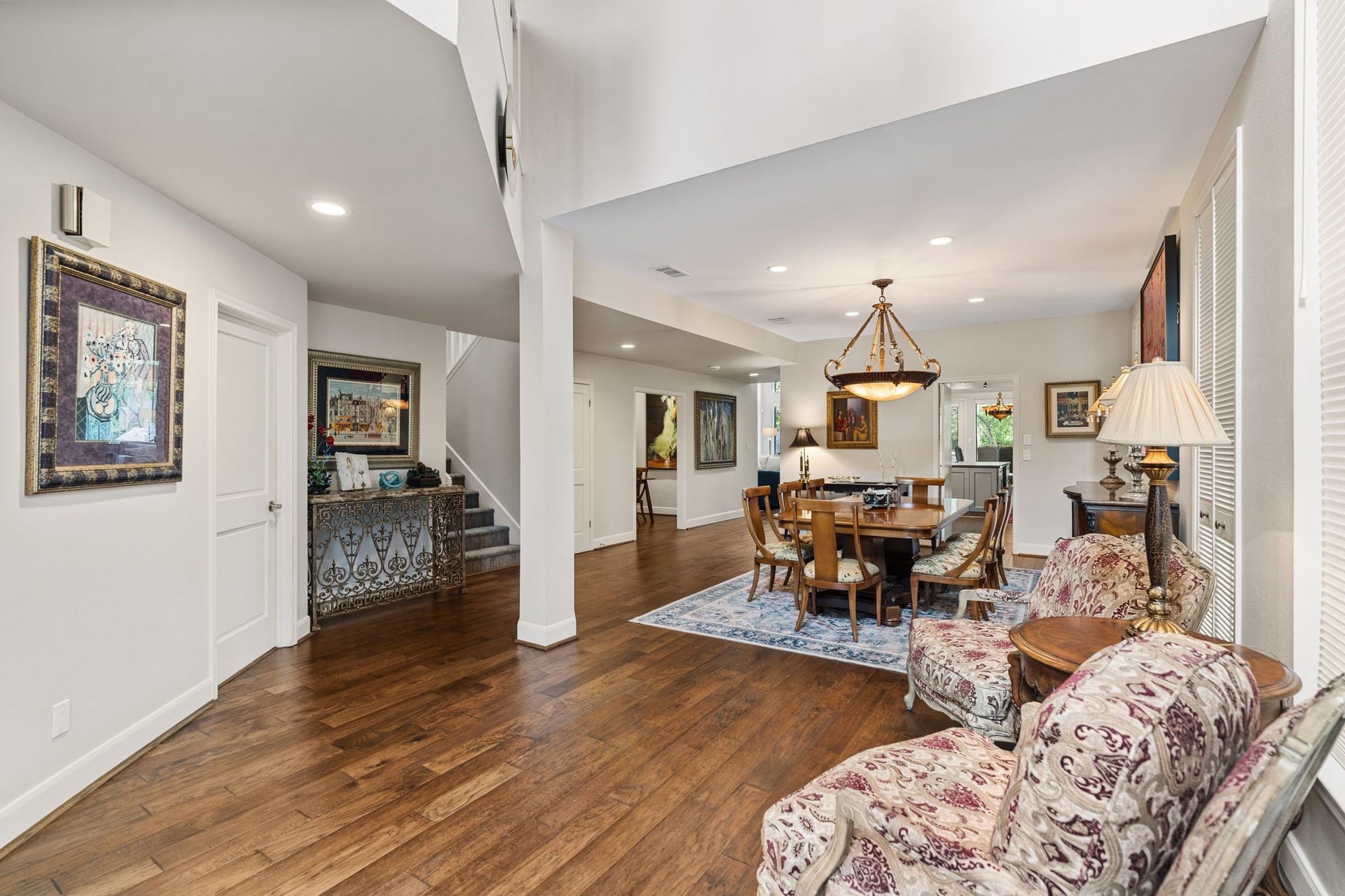 1918 Stoney Brook Drive, Houston, TX 77063 The soaring entry opens to a generous dining area, with warm wood flooring connecting the main gathering spaces.