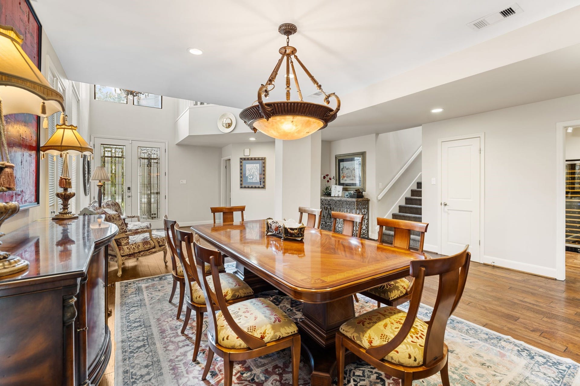1918 Stoney Brook Drive, Houston, TX 77063 This view toward the entry highlights decorative glass double doors, upper windows and the open connection between the foyer and dining area.