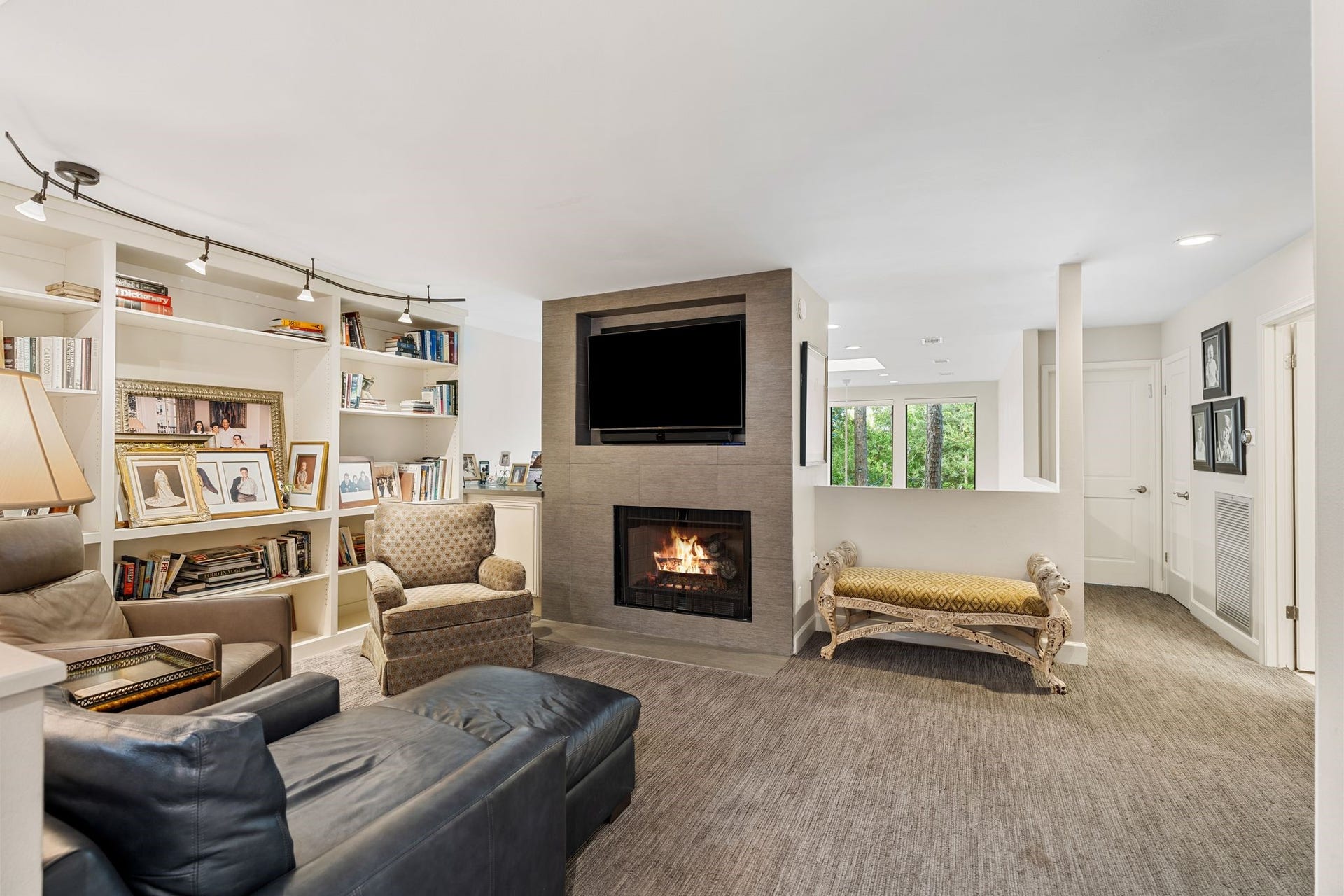 1918 Stoney Brook Drive, Houston, TX 77063 An upstairs den pairs a fireplace with a wall of built-in bookshelves, creating a comfortable retreat for reading, relaxing or movie nights.