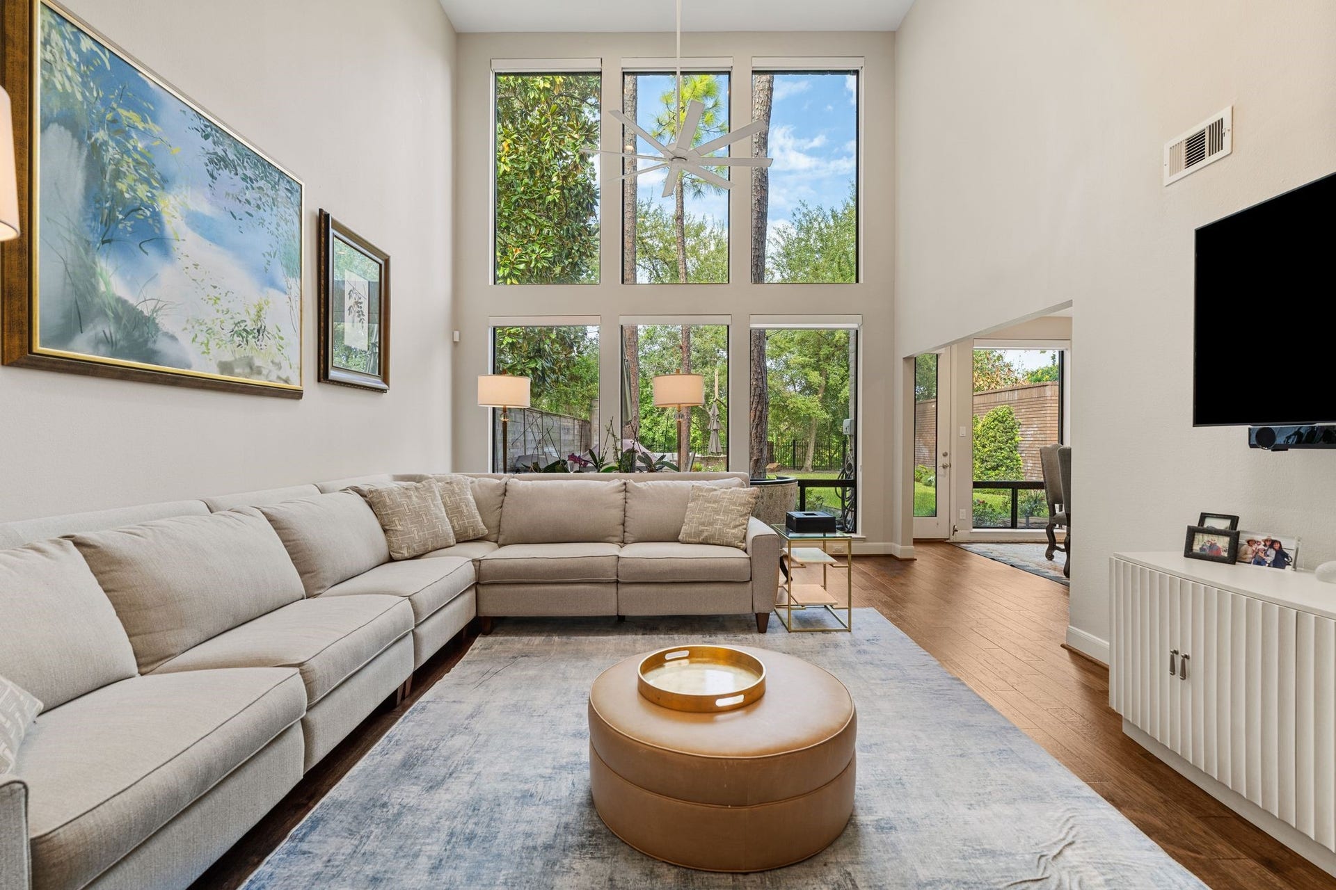 1918 Stoney Brook Drive, Houston, TX 77063 The airy living room offers generous seating space and an open connection to the breakfast area, with outdoor access nearby.
