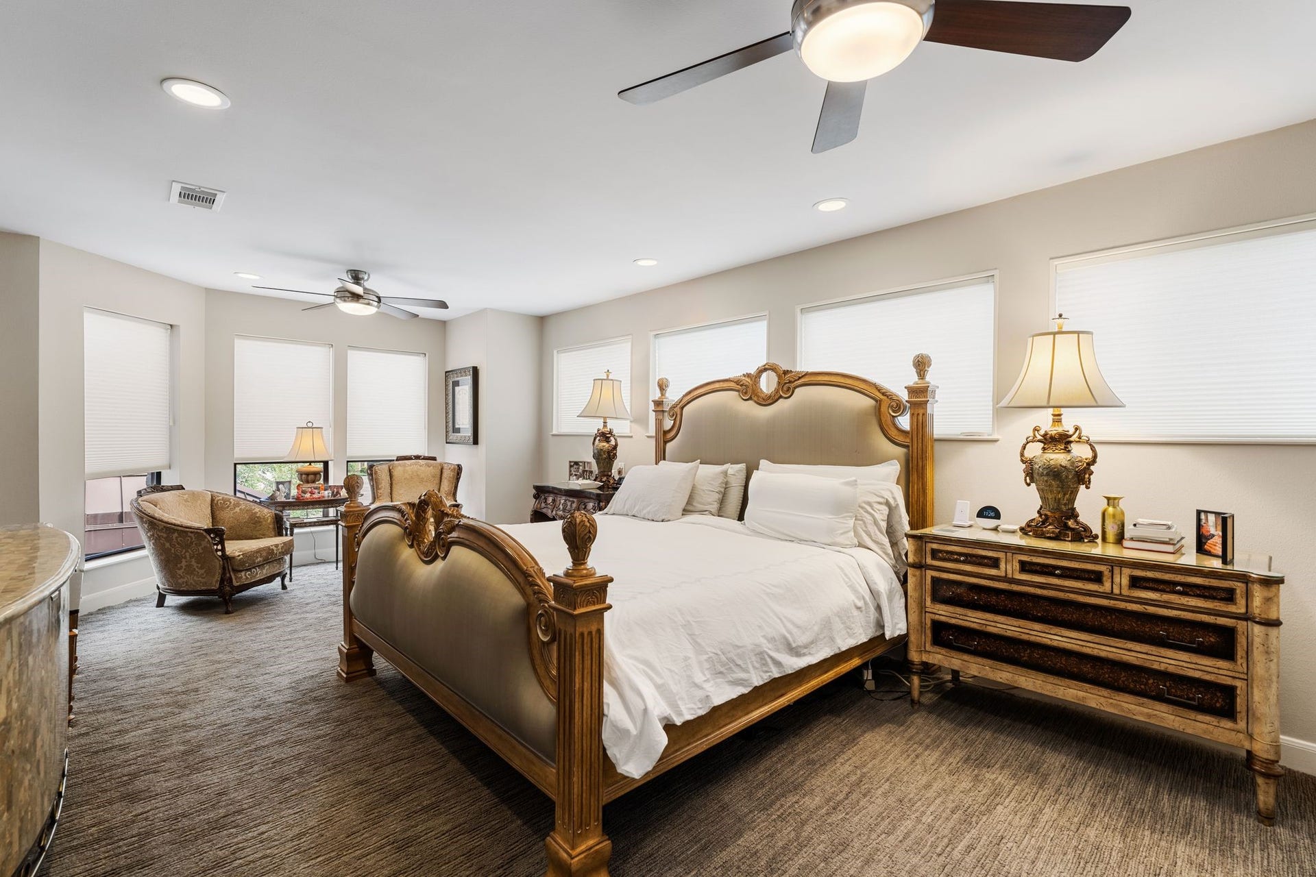 1918 Stoney Brook Drive, Houston, TX 77063 The primary bedroom extends into a windowed sitting area, providing ample room to unwind beyond the main sleeping space.