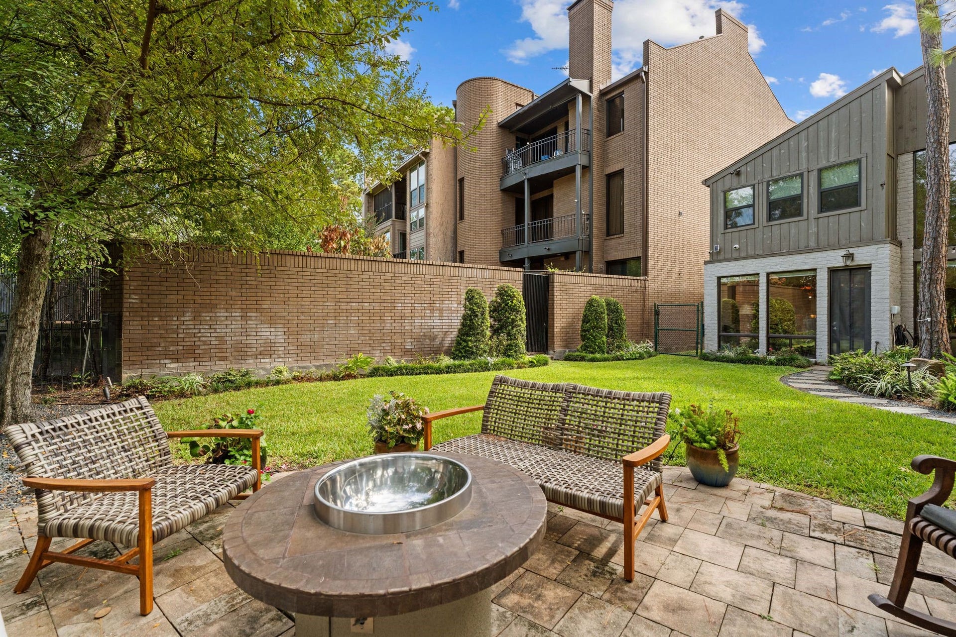 1918 Stoney Brook Drive, Houston, TX 77063 Looking back from the sitting patio, this view highlights the lawn, landscaped borders and rear of the home.