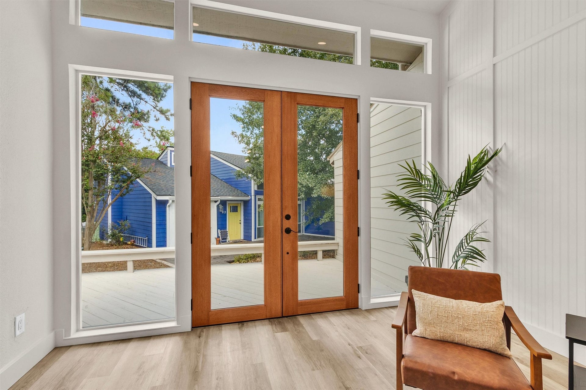 33 April Village, Montgomery, TX 77356 Walls of windows and gorgeous glass double doors fill the living space with natural light, creating a bright, airy atmosphere while beautifully connecting the indoors with the inviting front porch.