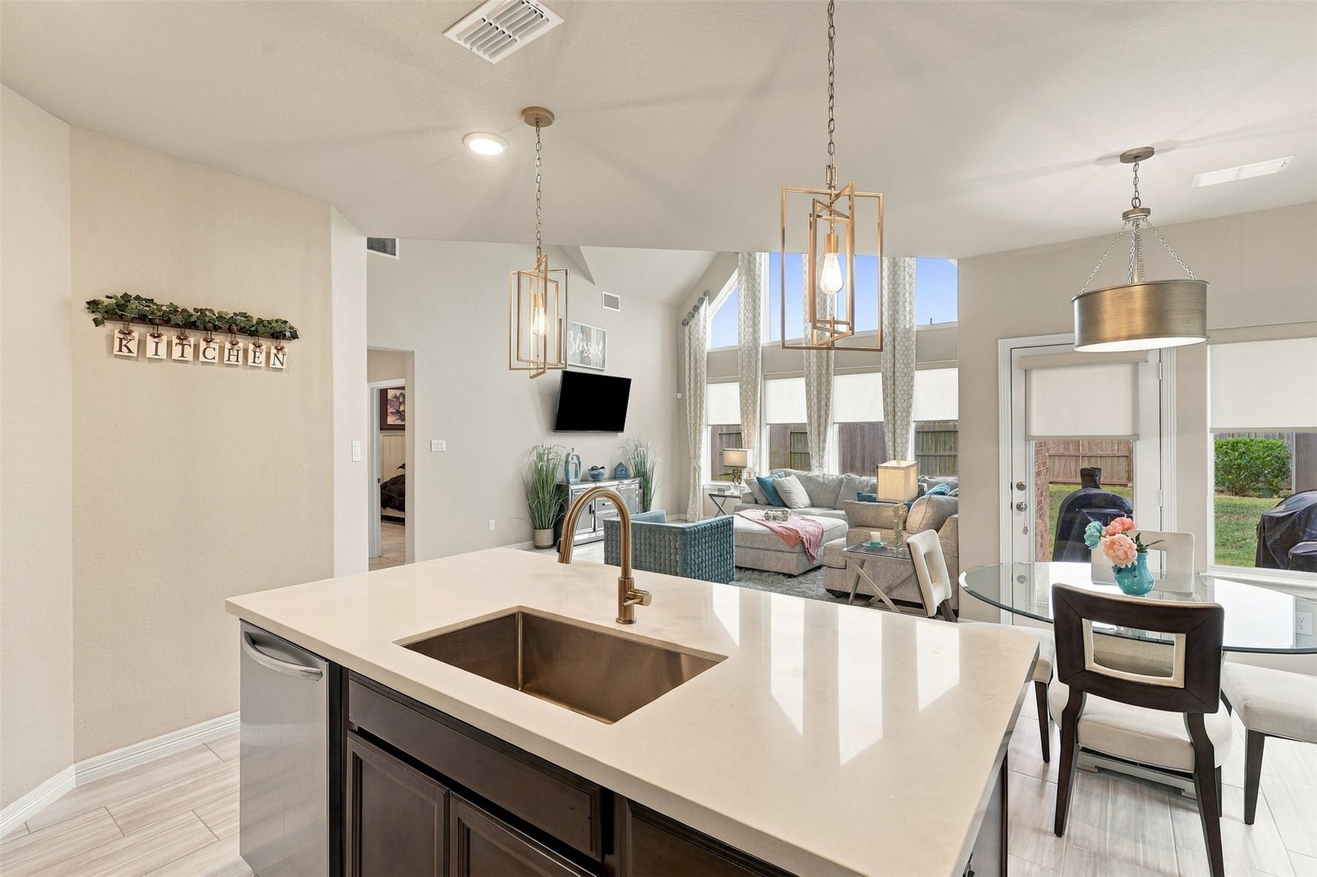 1719 Country Air Lane, Missouri City, TX 77459 THE HEART OF THE HOME & A TRUE SHOWSTOPPER! Prepare to be AMAZED by this breathtaking gourmet kitchen, where elegance meets extraordinary design! Gorgeous gleaming quartz countertops, a MASSIVE center island with sleek undermount sink, and dazzling designer pendant lighting create an unforgettable WOW FACTOR! But WAIT until you see the VIEW! This spectacular open-concept kitchen overlooks the magnificent family room with its soaring ceilings and dramatic walls of windows!