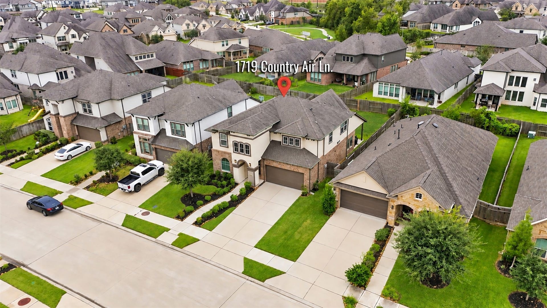 1719 Country Air Lane, Missouri City, TX 77459 A bird's-eye view of this beautiful home and its welcoming neighborhood! Enjoy a closer look at the attractive homes, well-maintained lawns, and neighborhood streets that create an inviting residential setting.