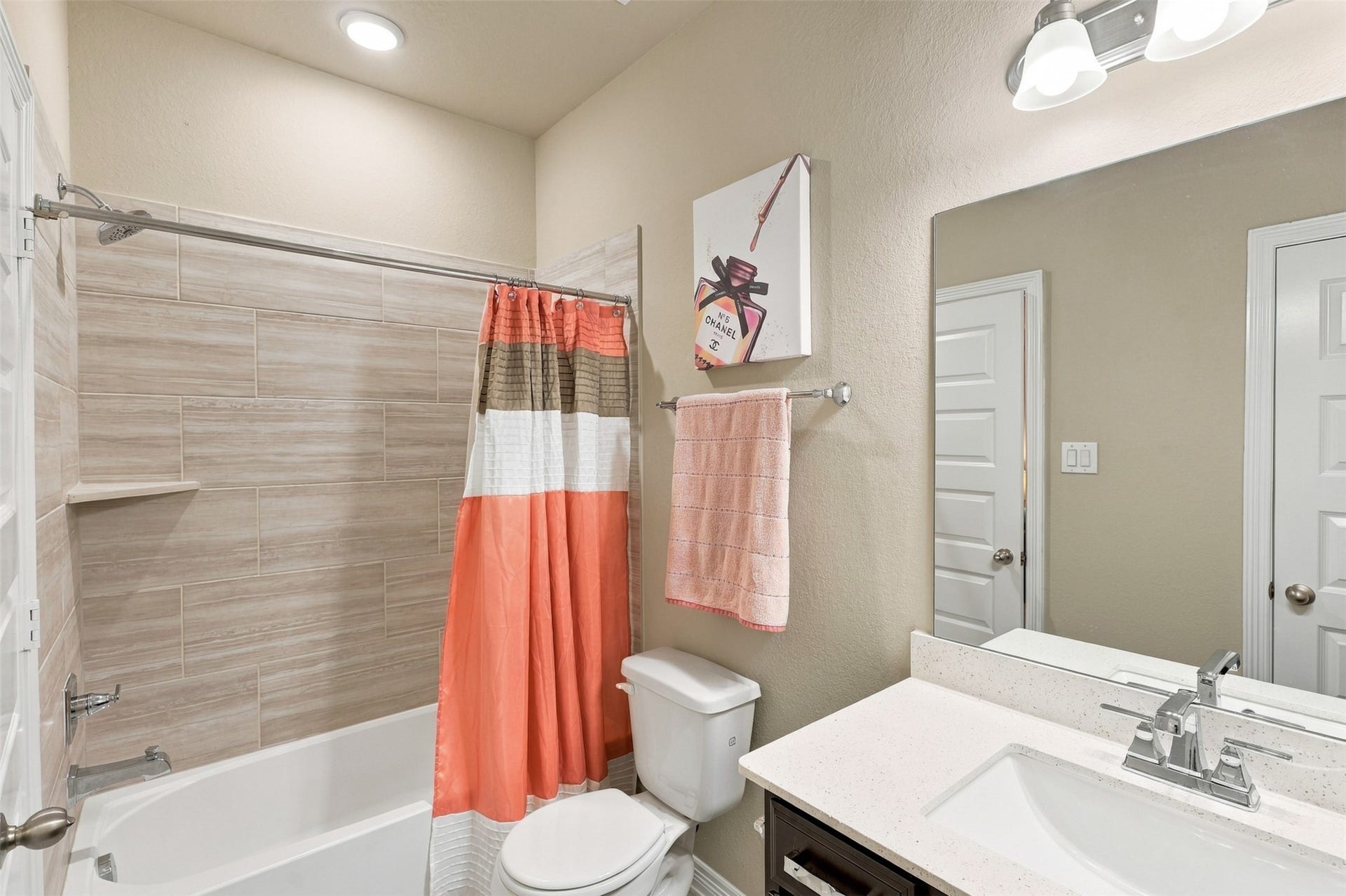 1719 Country Air Lane, Missouri City, TX 77459 A PRIVATE BATHROOM JUST FOR YOUR GUESTS! This BEAUTIFUL guest suite features its very own luxurious full bathroom, offering wonderful privacy and comfort! Gorgeous gleaming QUARTZ countertops, a deep undermount sink, and stunning designer tile surrounding the tub and shower combination create an elegant, spa-inspired atmosphere! And WAIT... there's MORE! A convenient LINEN PANTRY provides fantastic additional storage for towels and everyday essentials!