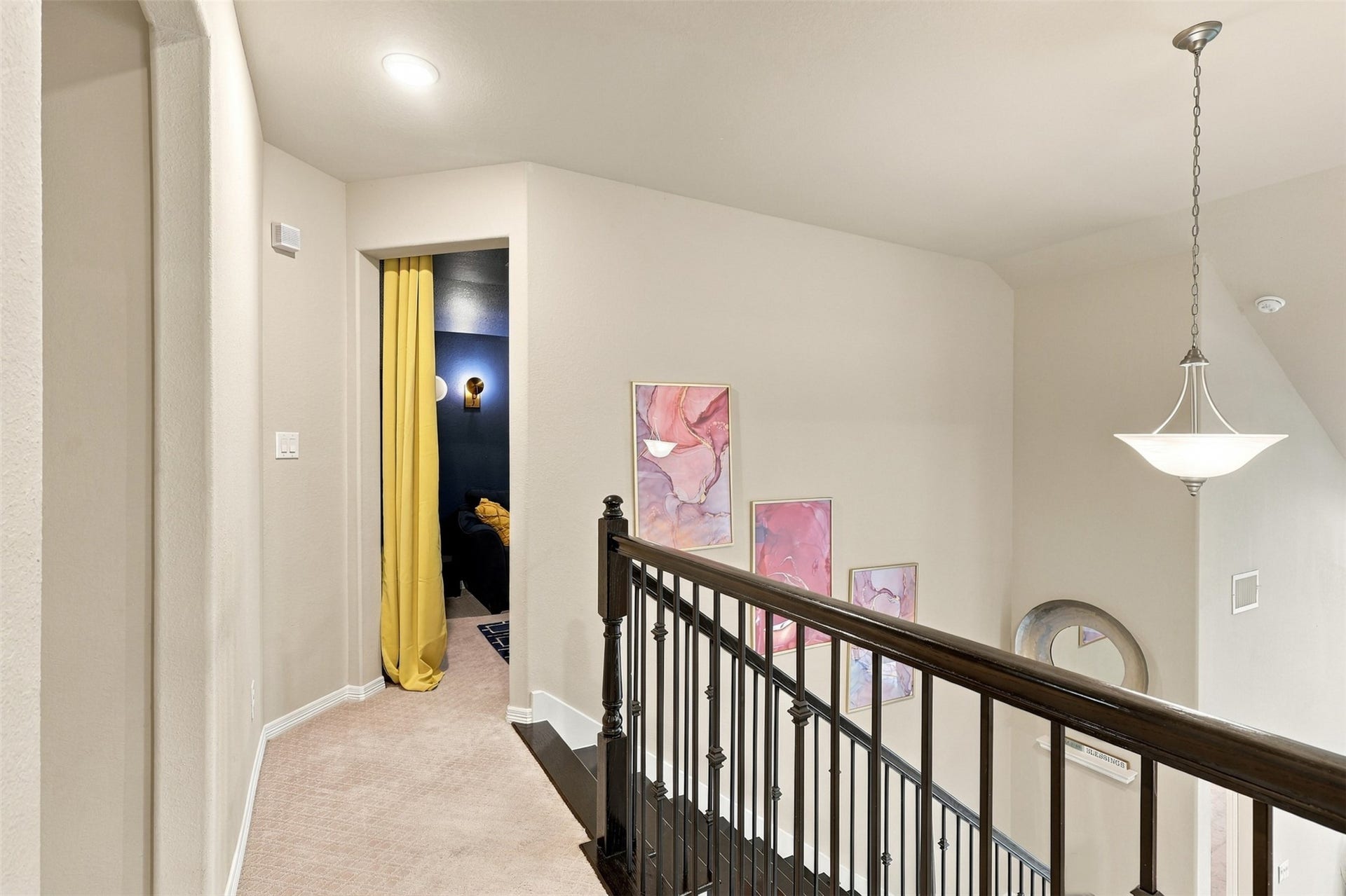 1719 Country Air Lane, Missouri City, TX 77459 A bright and welcoming upstairs landing offers a charming transition between the home's upper-level spaces. Soft neutral finishes, plush carpeting, and a stylish pendant light create a warm, comfortable atmosphere.