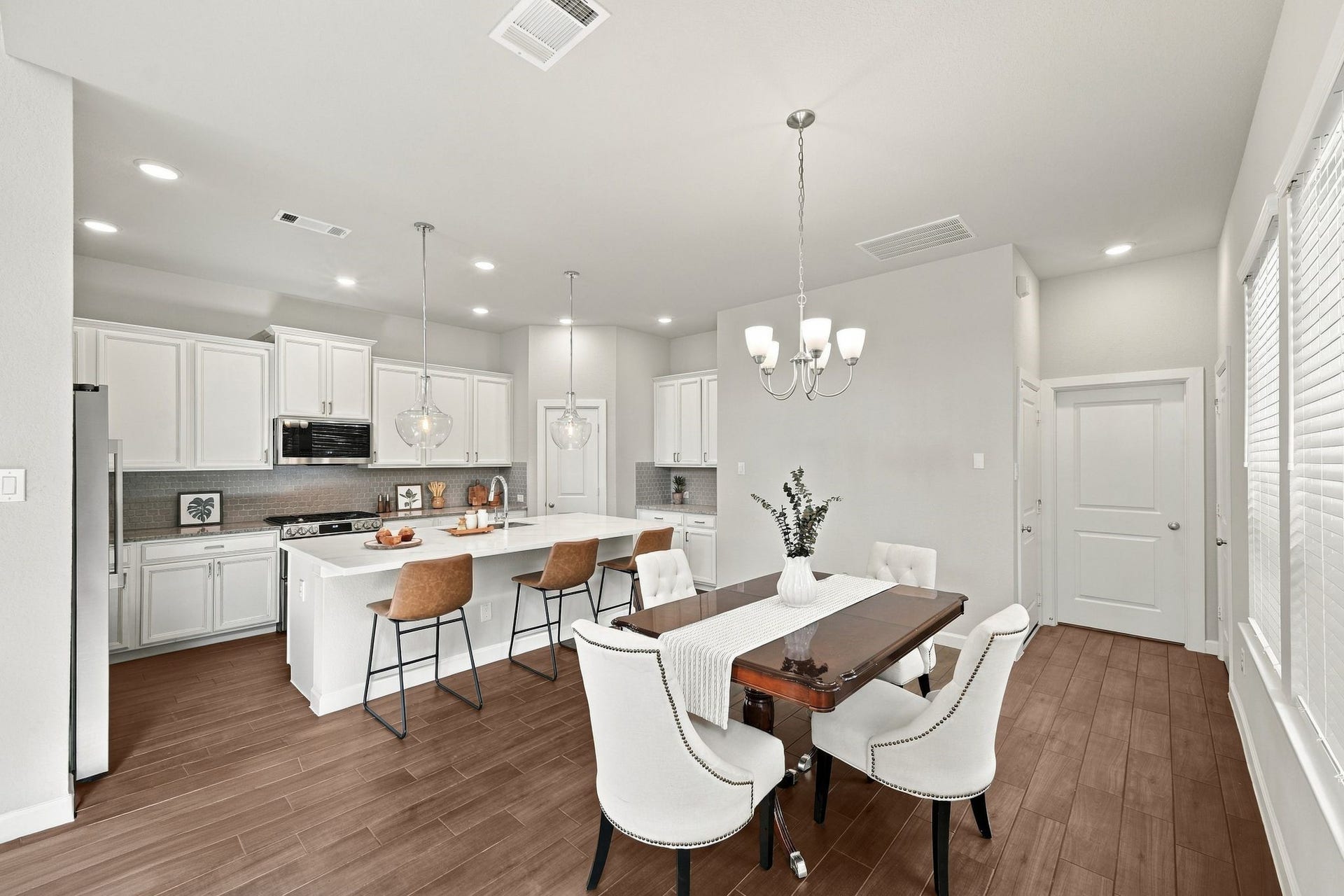 27022 Brighton Valley Way SW, Katy, TX 77494 White cabinetry, a quartz island, and a dining table built for full house dinners. Every inch works together.