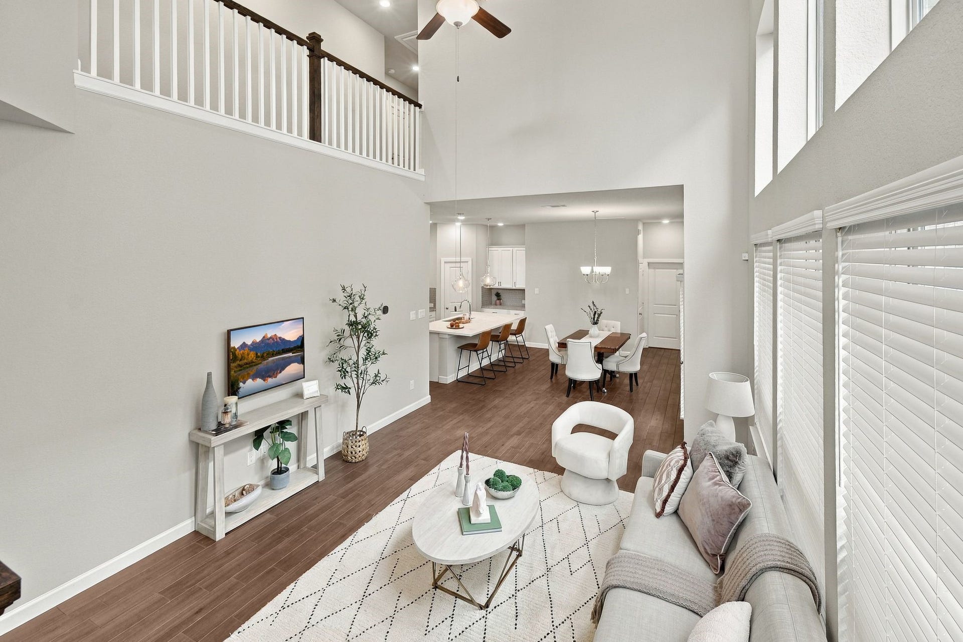 27022 Brighton Valley Way SW, Katy, TX 77494 From the loft, the whole first floor unfolds, kitchen, dining, and living room in one line of sight.