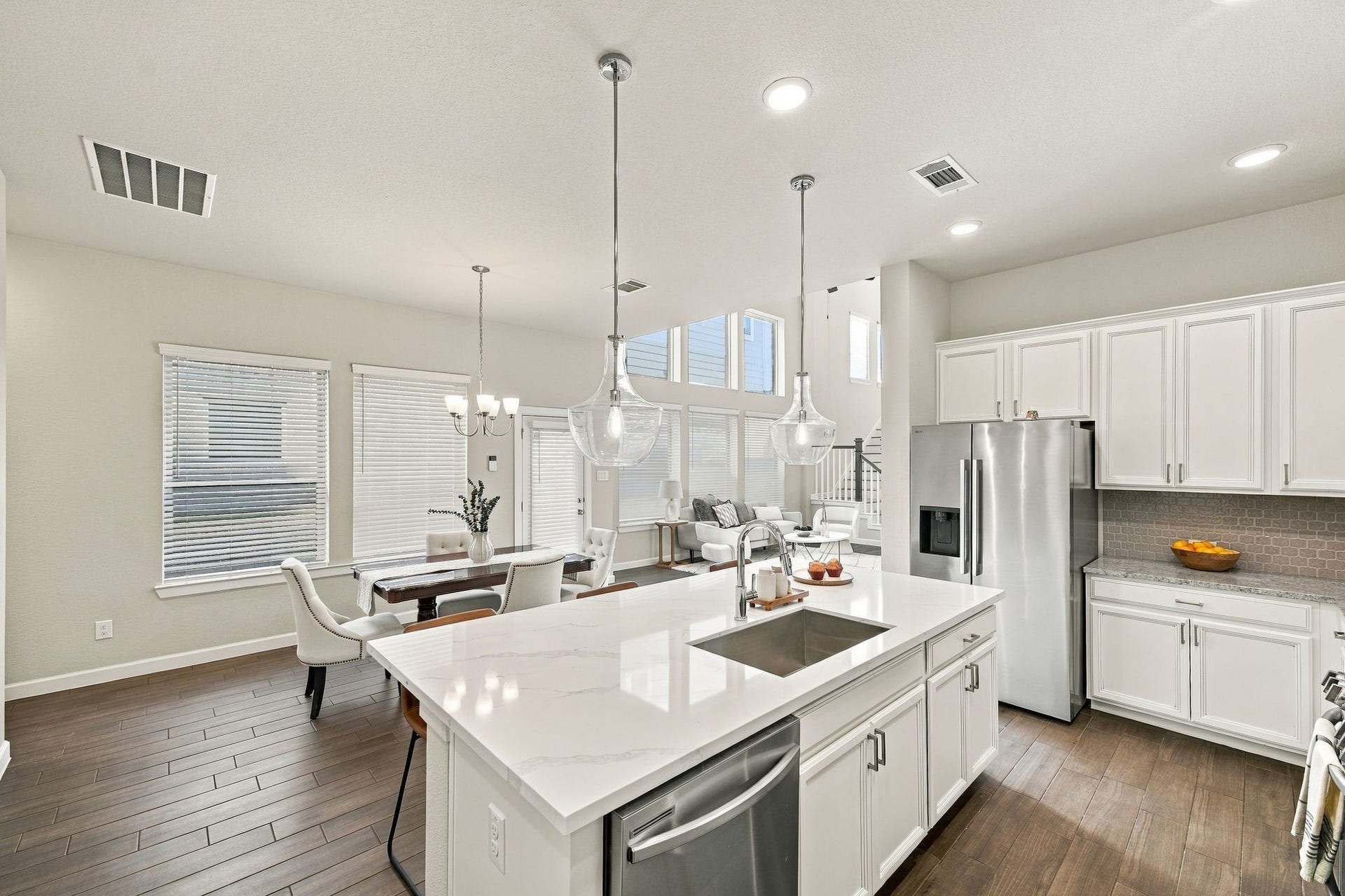 27022 Brighton Valley Way SW, Katy, TX 77494 Stainless refrigerator, quartz island, dining and living room in clear view. Cooking here means never leaving the conversation.