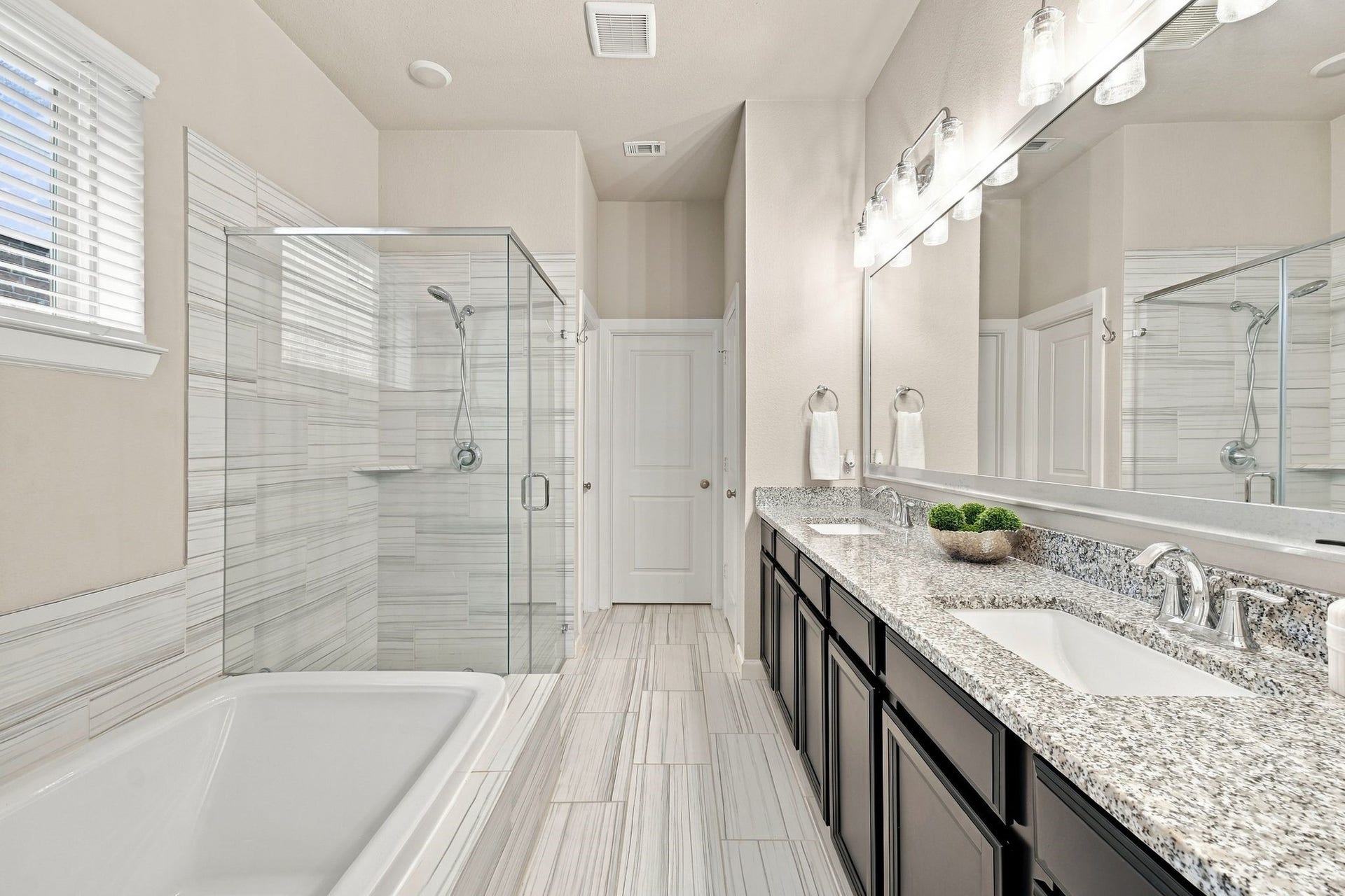 27022 Brighton Valley Way SW, Katy, TX 77494 Dual vanity, a soaking tub, and a glass shower finished in floor to ceiling tile. This is where the day starts and ends right.