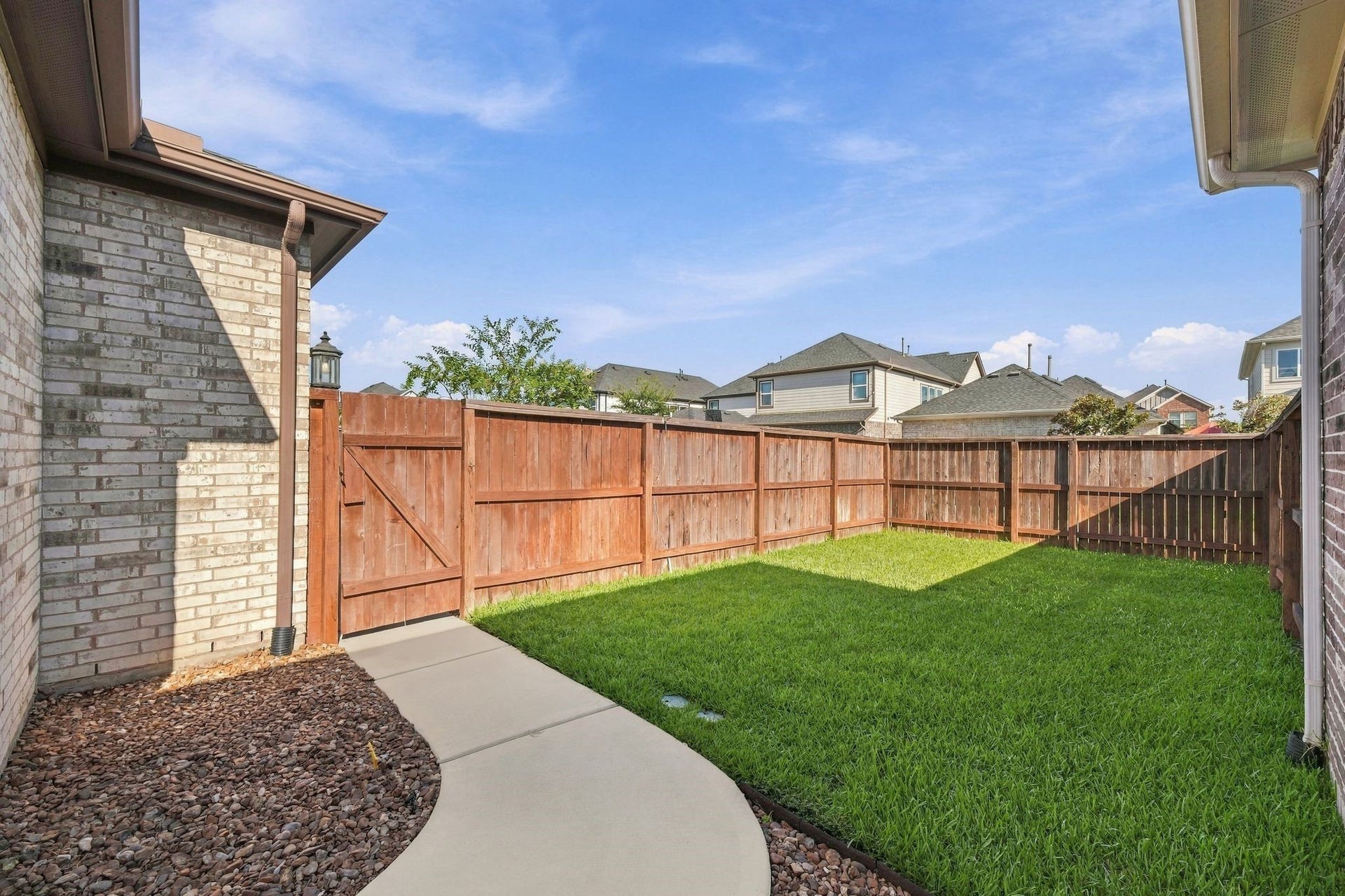 27022 Brighton Valley Way SW, Katy, TX 77494 A private backyard framed by a wood fence. Room to grill, garden, or just sit outside.