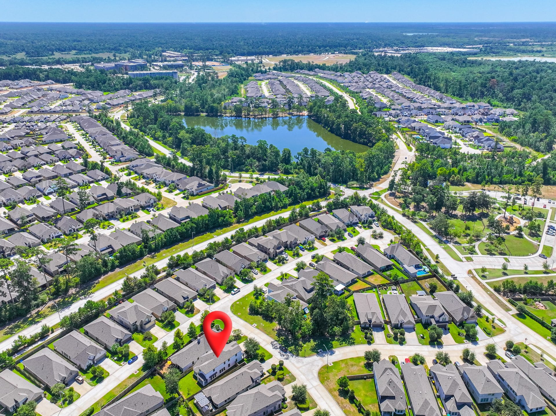 706 Santa Elena Trail, Conroe, TX 77304 Overhead community aerial showcasing Grand Central Park's beautifully planned layout tree-lined streets, the expansive 88-acre Grand Lake, neighborhood parks, and exceptional recreational amenities spread throughout this extraordinary Conroe, TX community.