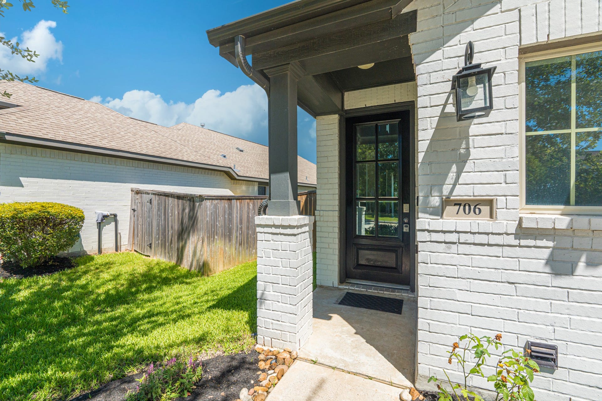 706 Santa Elena Trail, Conroe, TX 77304 The covered front entry makes a stunning first impression stone surround, dark paneled front door, and a warm lantern-style sconce light create an inviting arrival experience that sets the stage for the quality and style you'll find throughout the home.