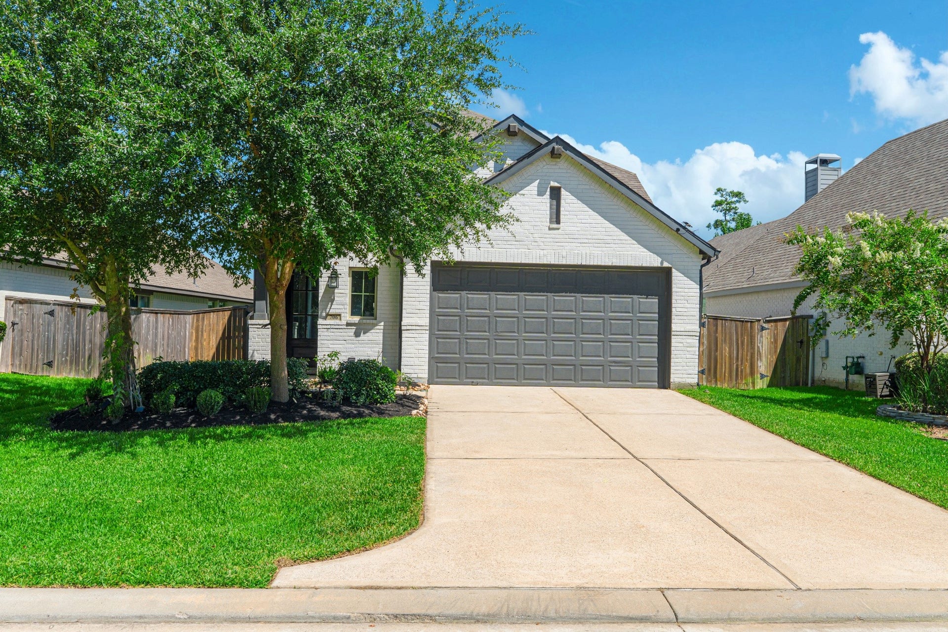 706 Santa Elena Trail, Conroe, TX 77304 Street-level view of this beautiful home that is ready now for immediate move in in one of North Houston highly rated master planned communities - Grand Central Park.