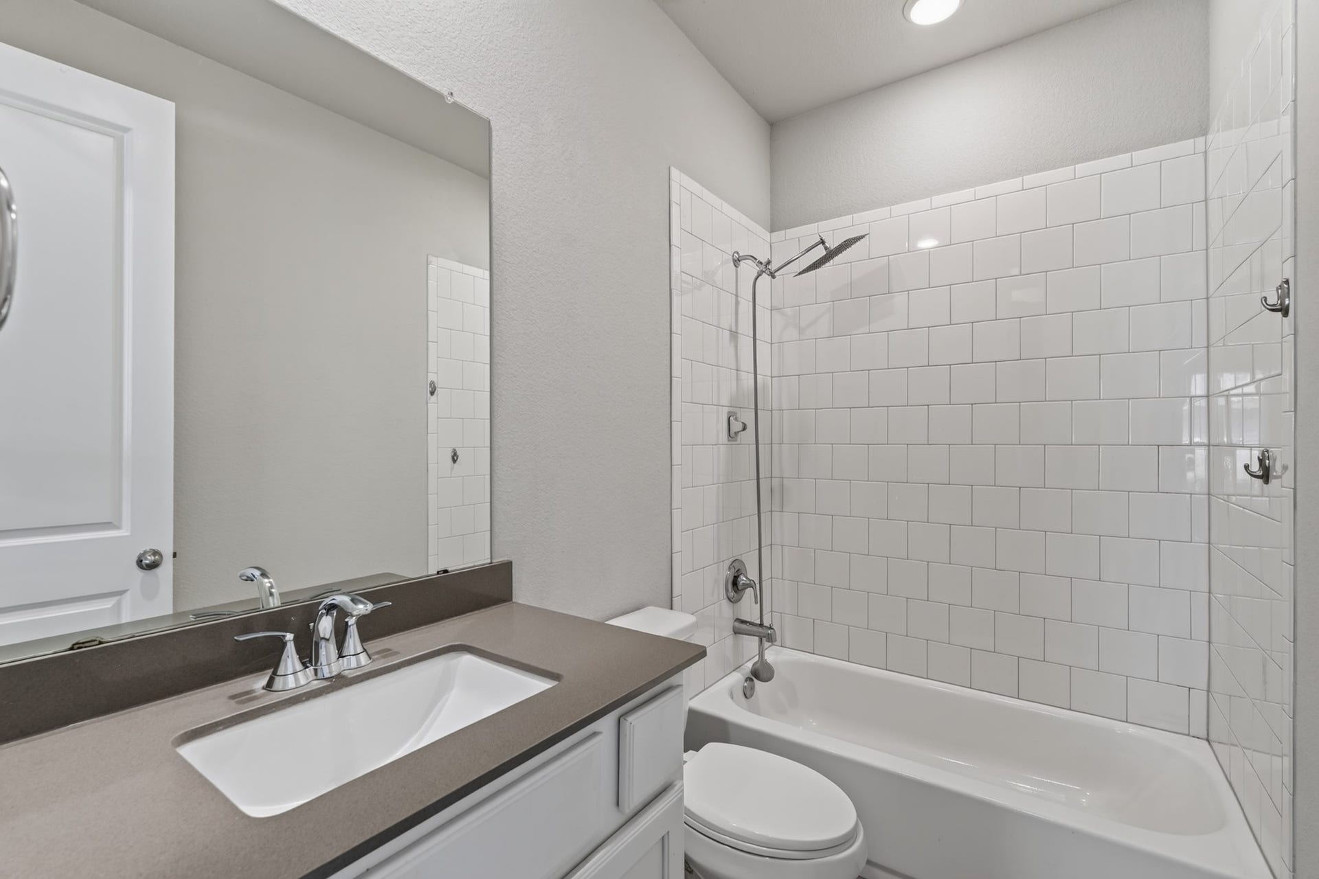 706 Santa Elena Trail, Conroe, TX 77304 Convenient full bathroom near the secondary bedrooms featuring a vanity with sink, toilet, and clean neutral finishes. Functional design and easy-care surfaces make this bathroom both practical for daily use and refreshingly simple to keep maintained.