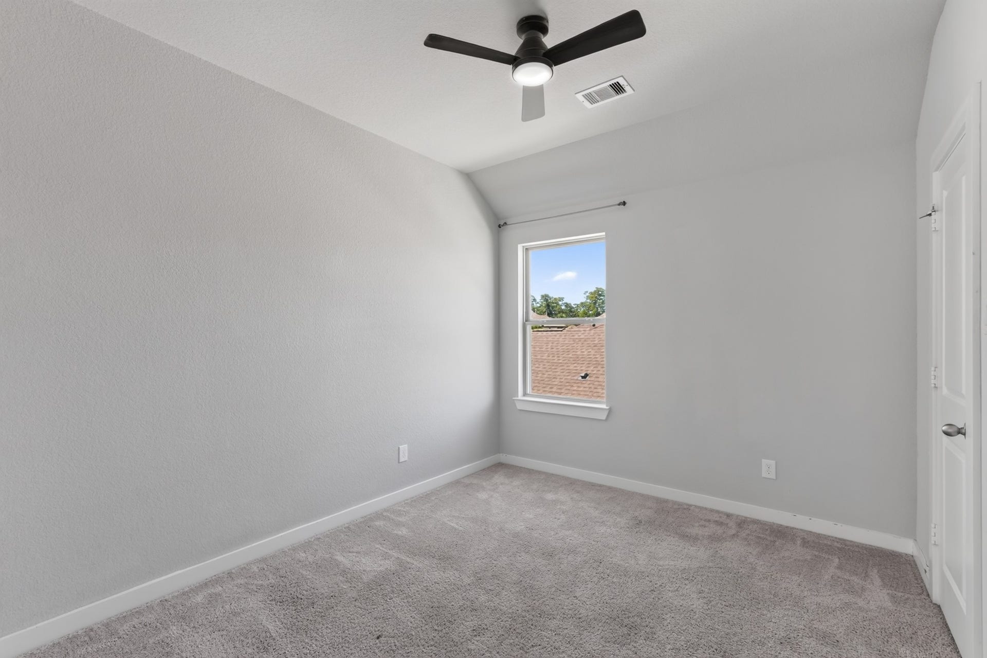 706 Santa Elena Trail, Conroe, TX 77304 Third secondary bedroom with a ceiling fan, soft carpet flooring, and a window for natural light. Neutral tones make decorating easy, giving future occupants the freedom to personalize this bright, comfortable room exactly the way they want it.