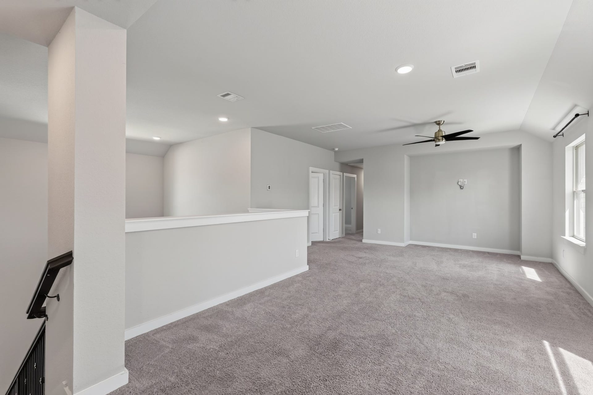 706 Santa Elena Trail, Conroe, TX 77304 The upstairs game room is a spectacular bonus space large, open, and flexible with plush carpet, a ceiling fan, and bright neutral walls. Use it as a playroom, media room, home gym, or second family living area for the whole household to truly enjoy.