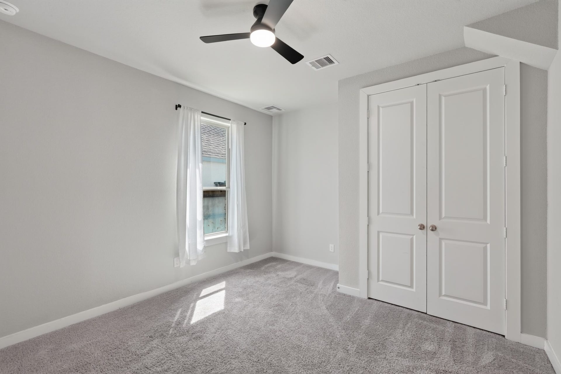 706 Santa Elena Trail, Conroe, TX 77304 Secondary bedroom featuring plush carpet, a ceiling fan, and a closet a comfortable, well-lit room ready for family, guests, or a home office. Neutral walls make personalizing this warm and inviting space effortless from the very first day of move-in.